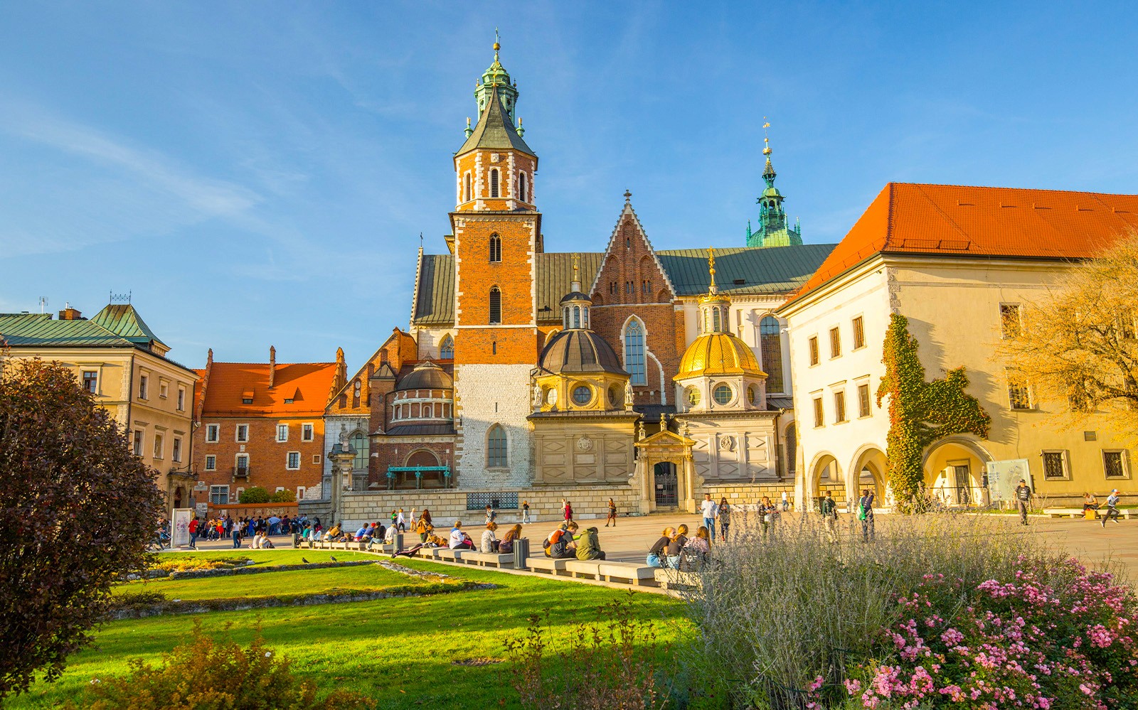 Wawel Cathedral in Krakow with tourists exploring the grounds.