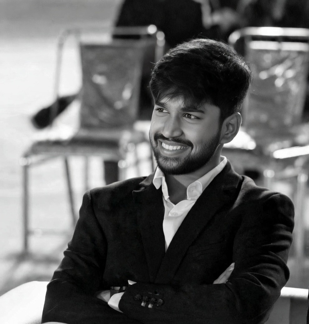 Peace Badejo, wearing sunglasses, looking to the left.