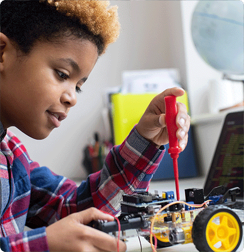 Student developing STEM skills through robotics activities funded by school grants