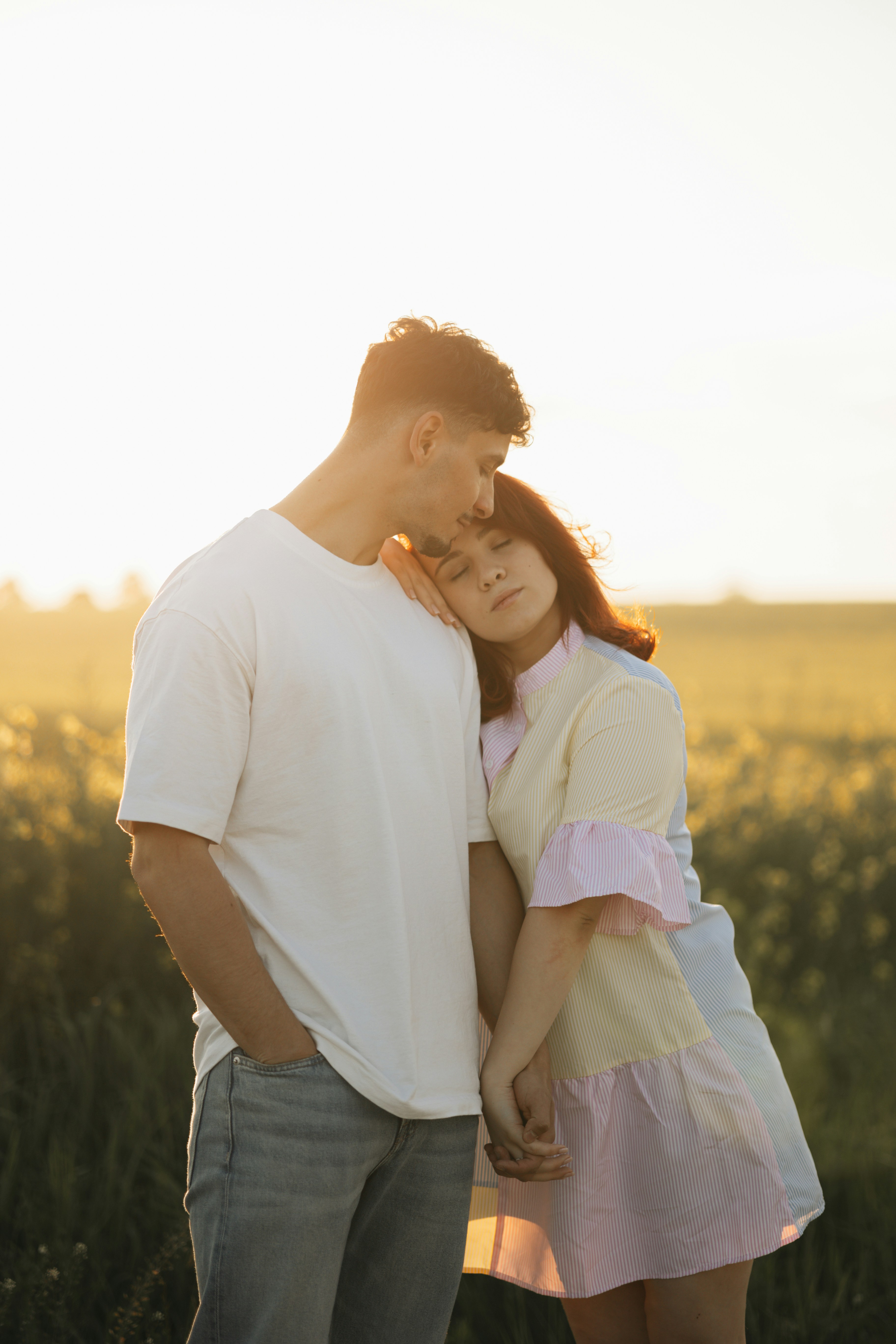 A man and a woman standing in a field