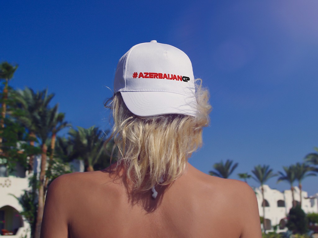 A close-up of a hand wearing multiple decorative rings against a blue background.