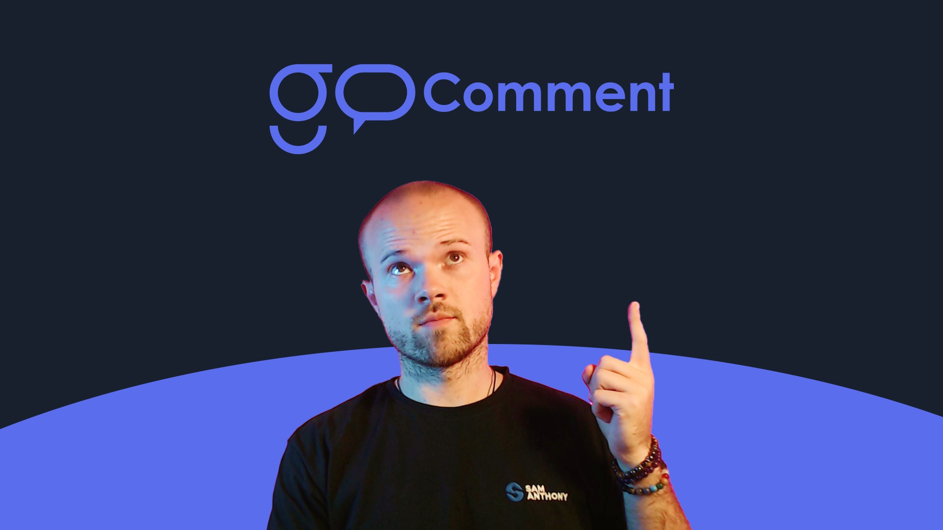 Web designer Sam Anthony pointing up at the GoComment logo.