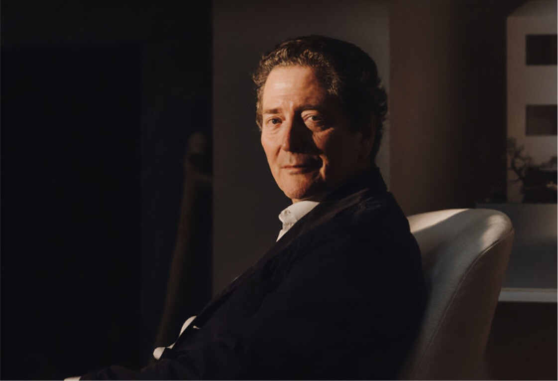 portrait of man sitting in chair with warm lighting