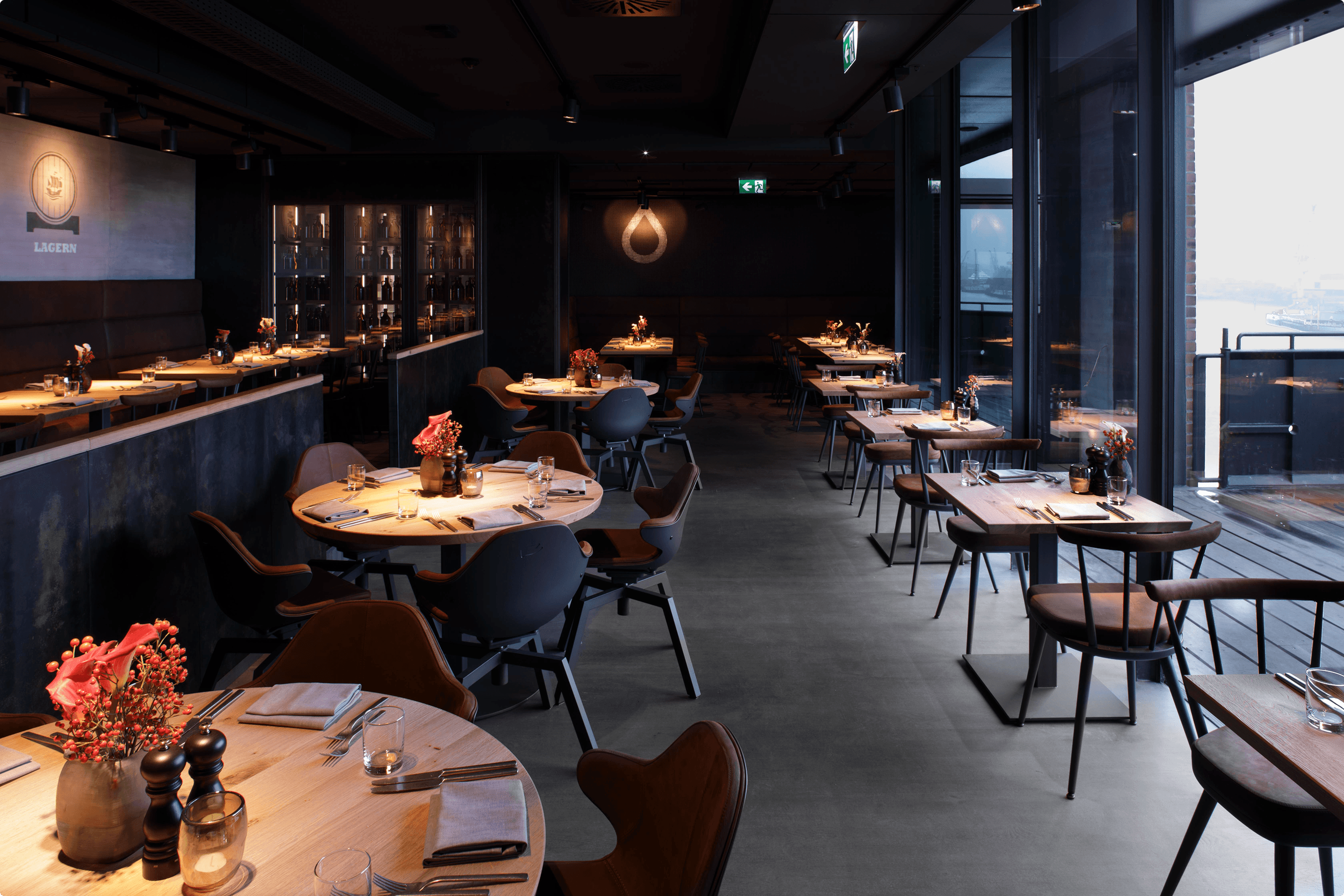 Modern restaurant interior with dining tables and chairs.