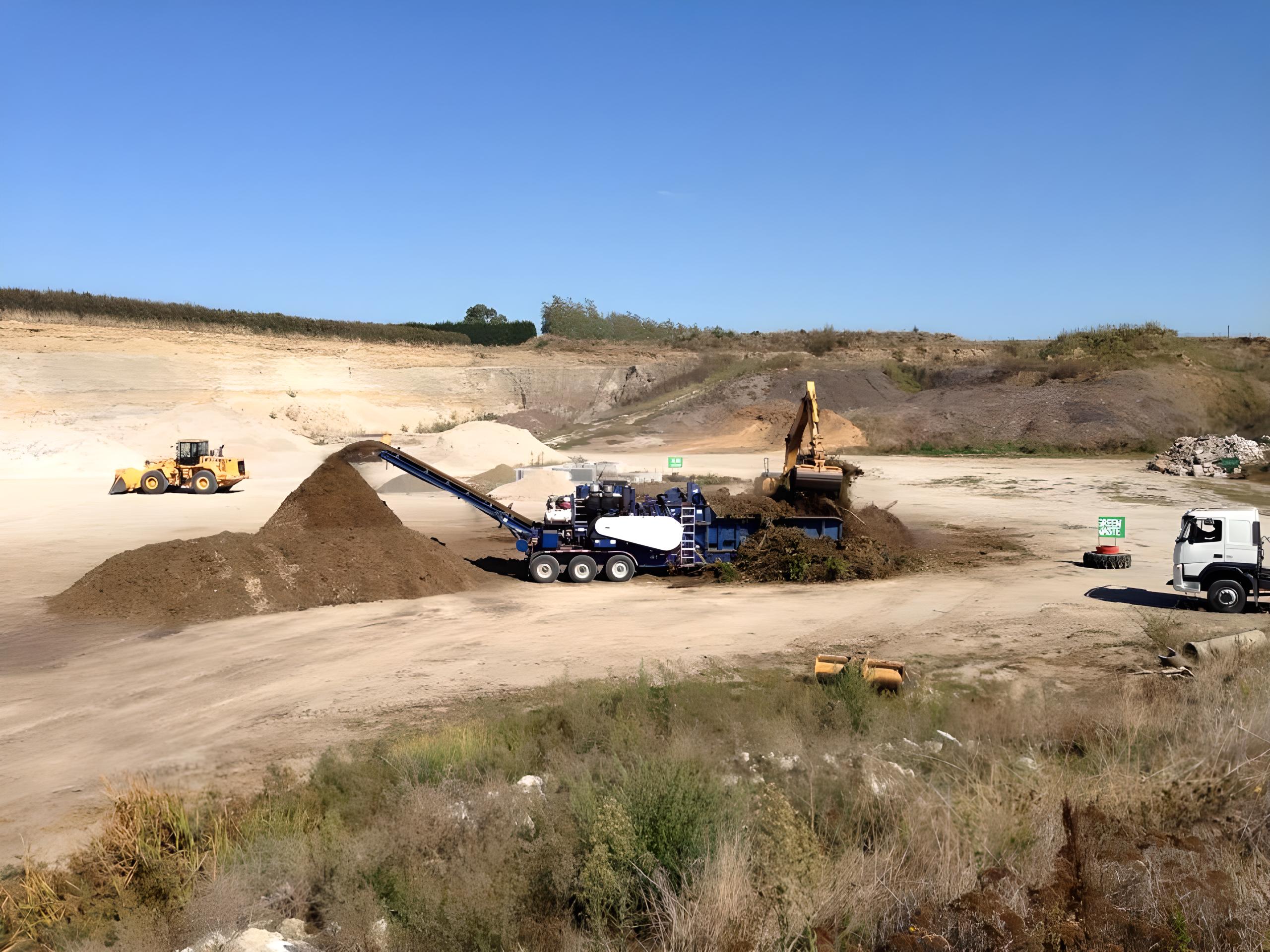 Santa holding a christmas tree in a sand quarry