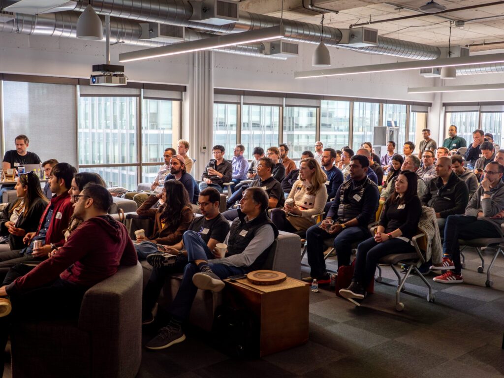 people sitting in a conference room at the FC build generative ai conference