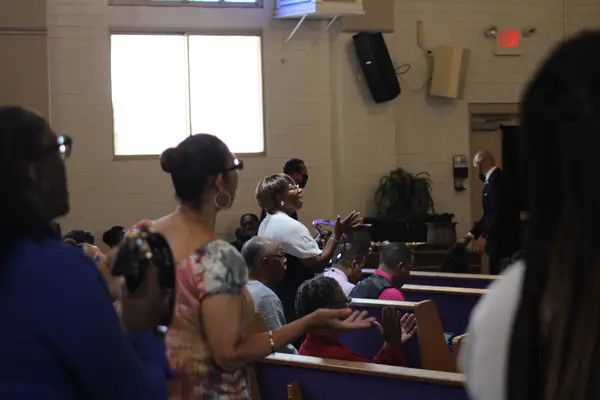 Church members worshipping together during a service at Peace Apostolic Church