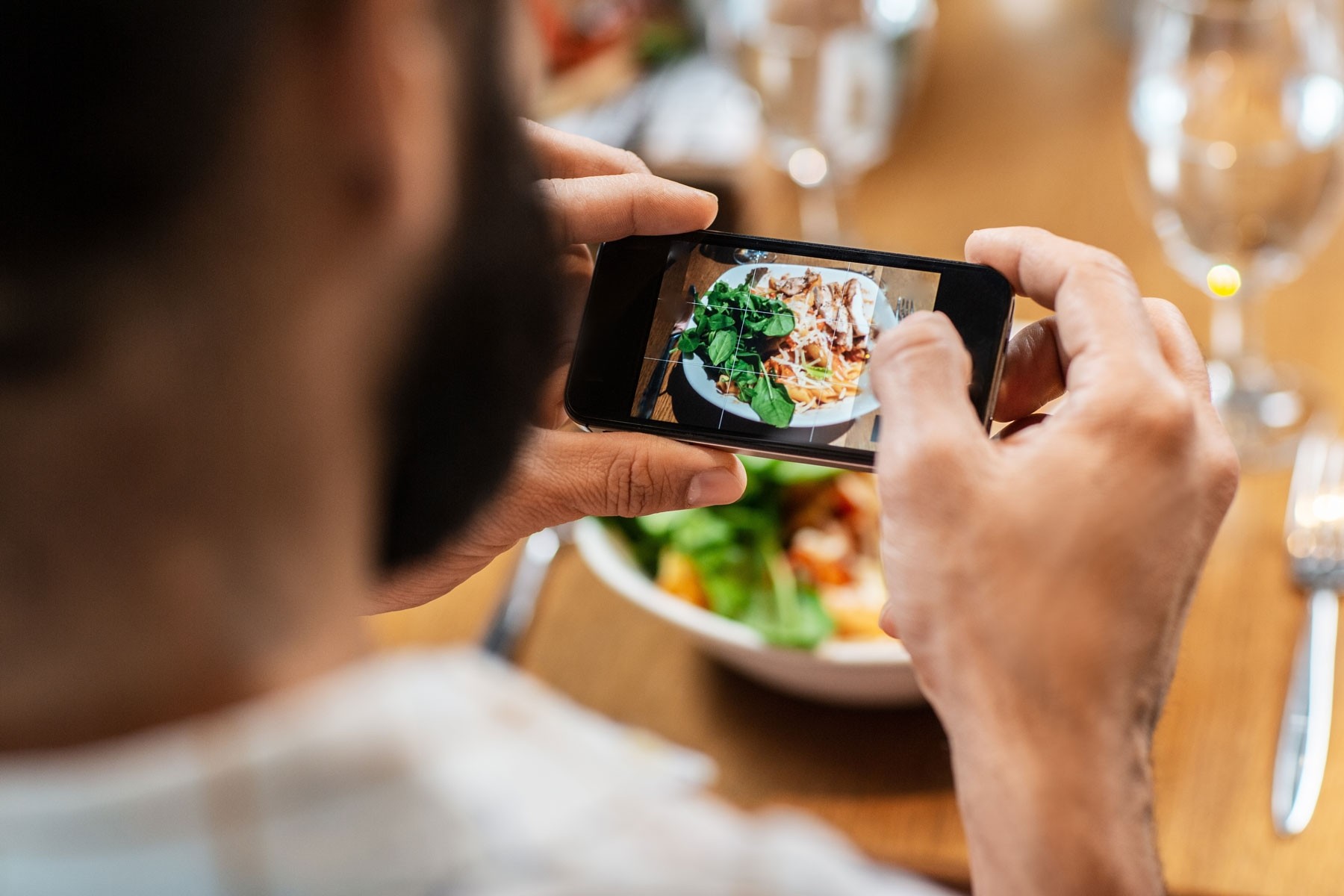 person taking a picture of their food