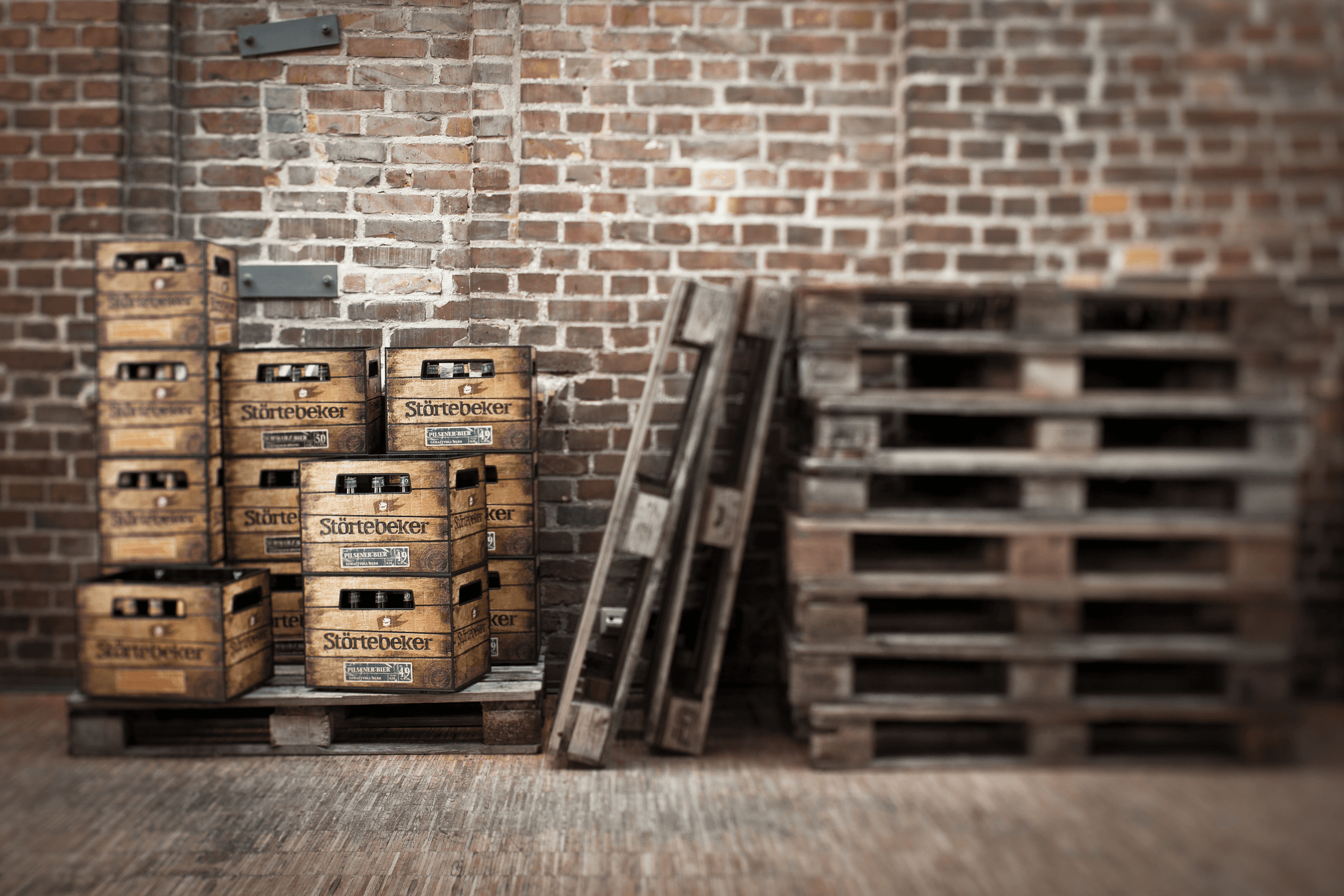Wooden crates of Störtebeker beer bottles stacked on pallets.