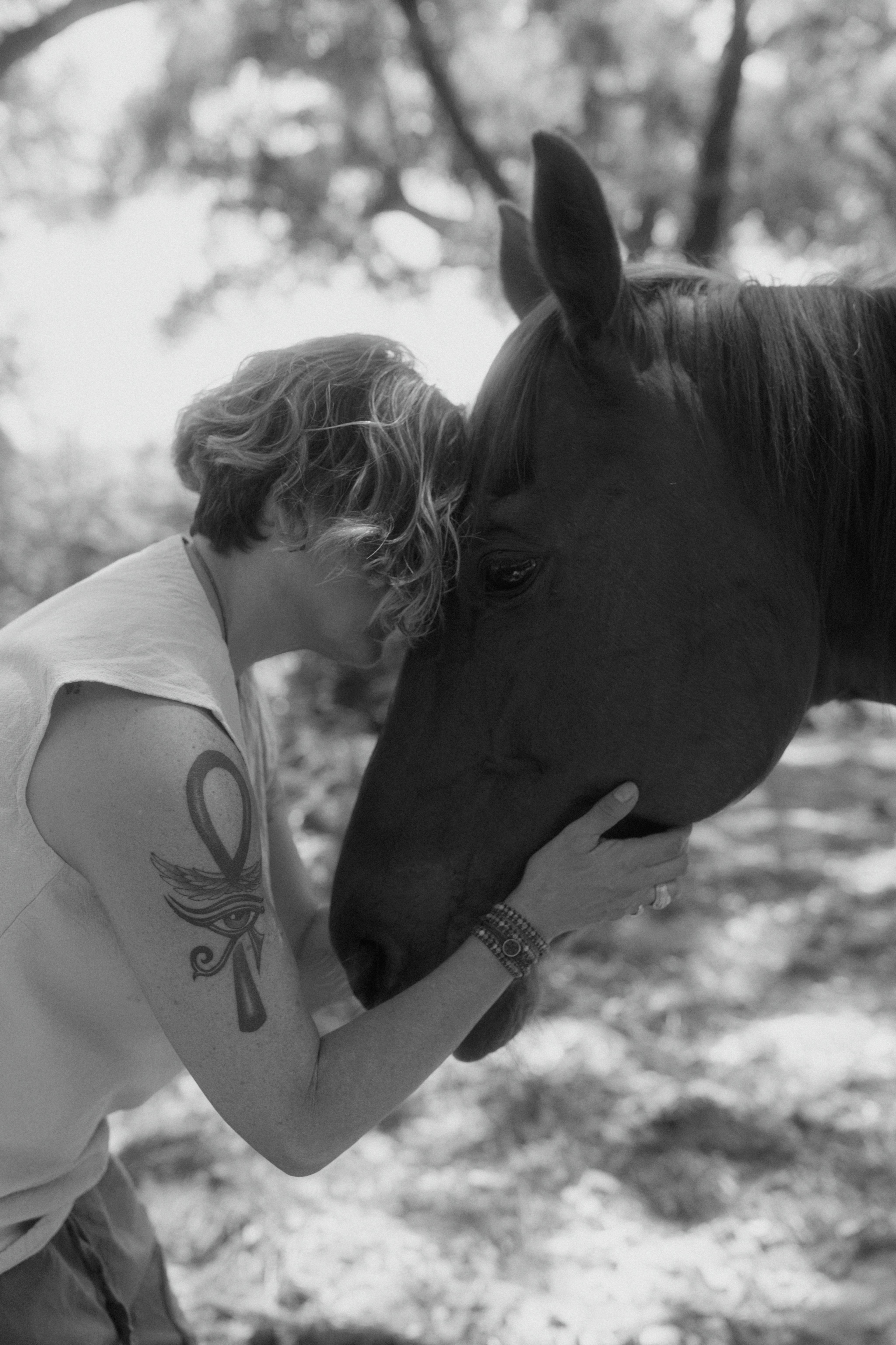 Sonia in a close black and white moment of connection with Corona the horse