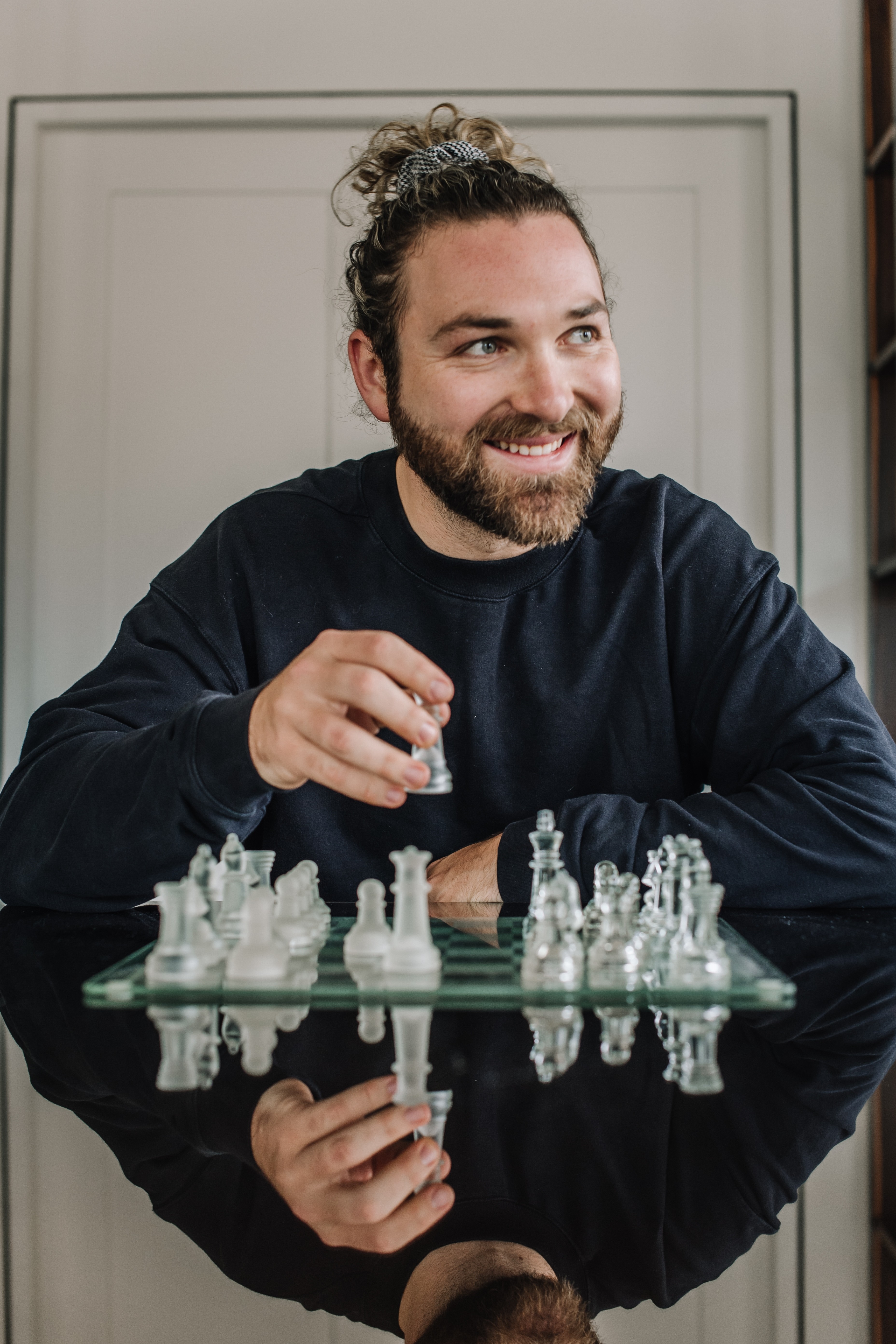 Black cosmetic product bottle against a dark background