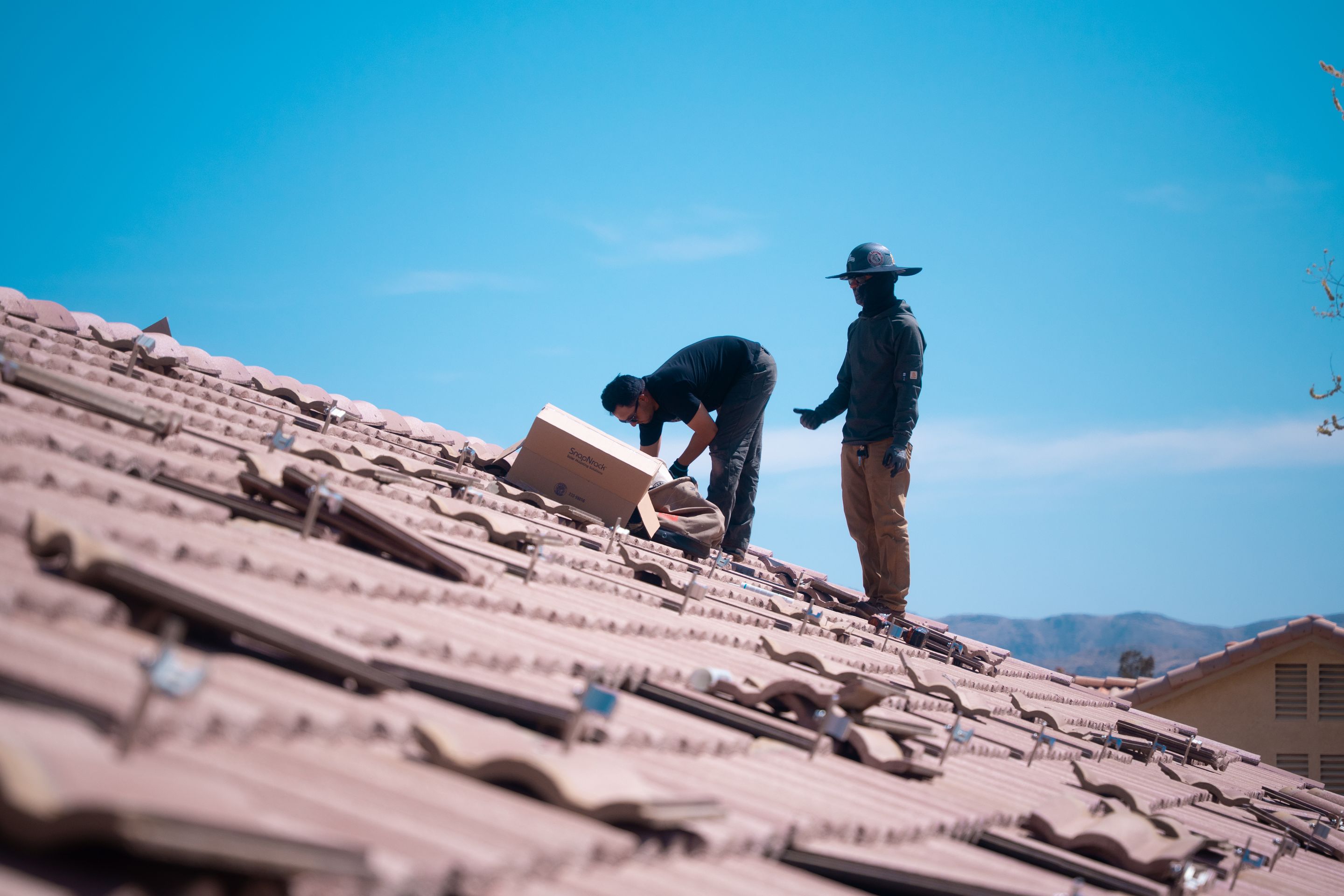 Option One Solar crew working on a tile roof