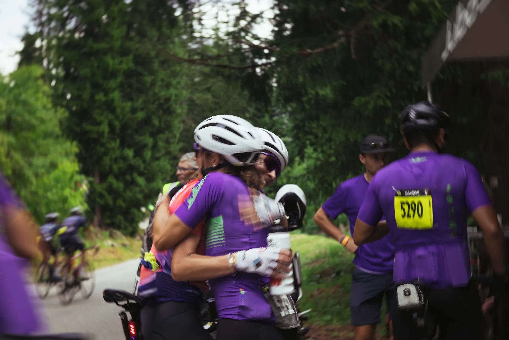 Two Julbo cyclists embracing at the finish line - moment of support and emotion
