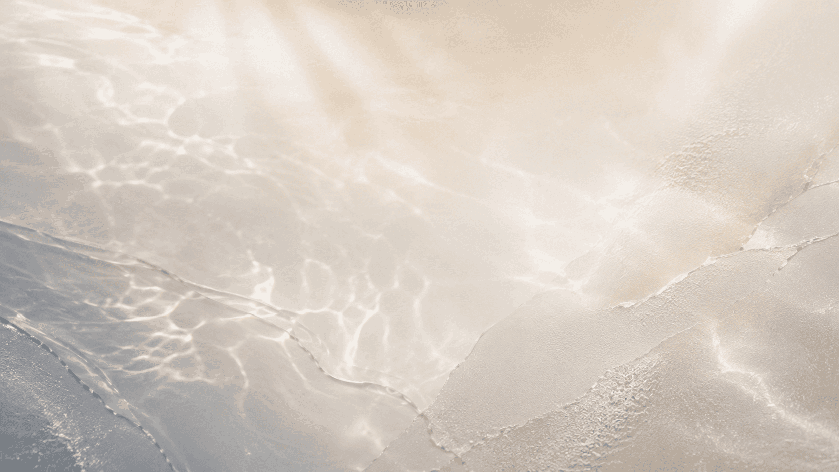 A serene and elegant spa space with wooden reclining chairs and white cushions. Golden sunlight filters through a cascading water feature, creating a peaceful atmosphere. Tropical plants and candles add to the relaxing ambiance.
