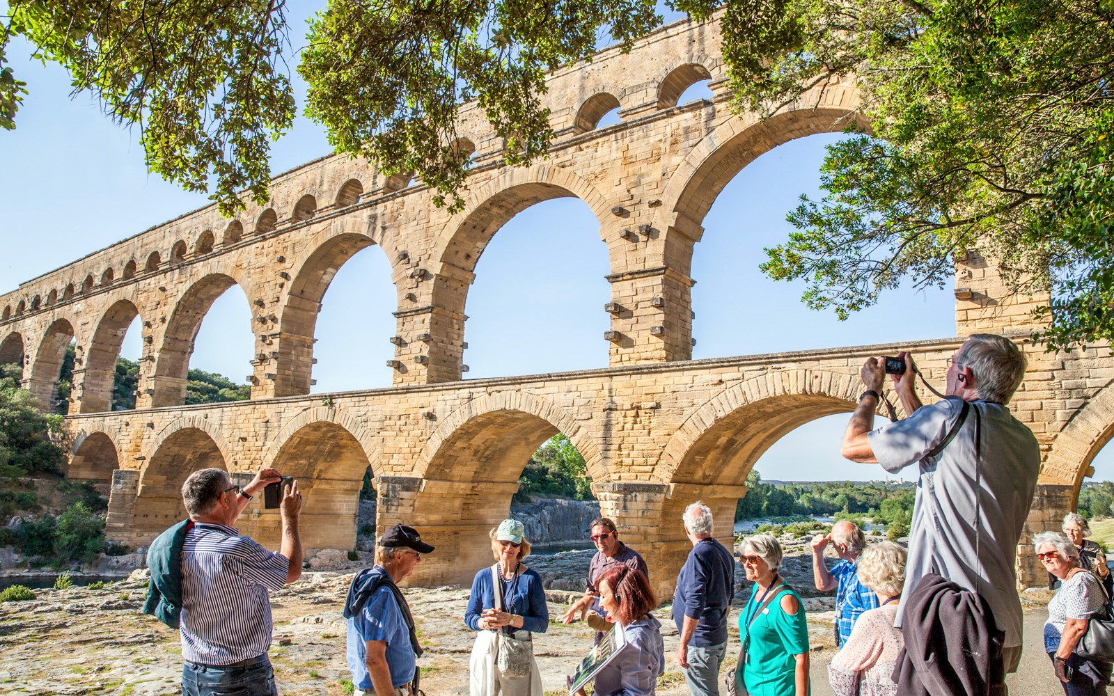 Visitors exploring Pont du Gard aqueduct in France with skip-the-line tickets.