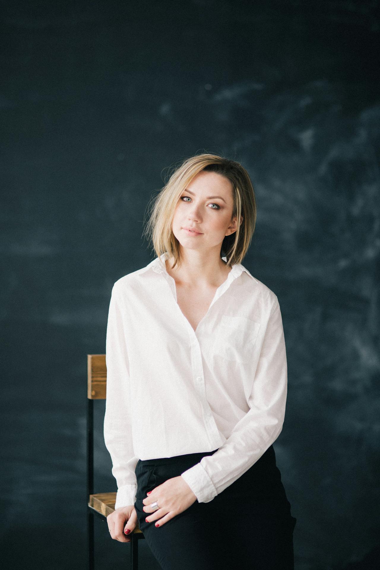 a girl wearing white shirt looking at the camera