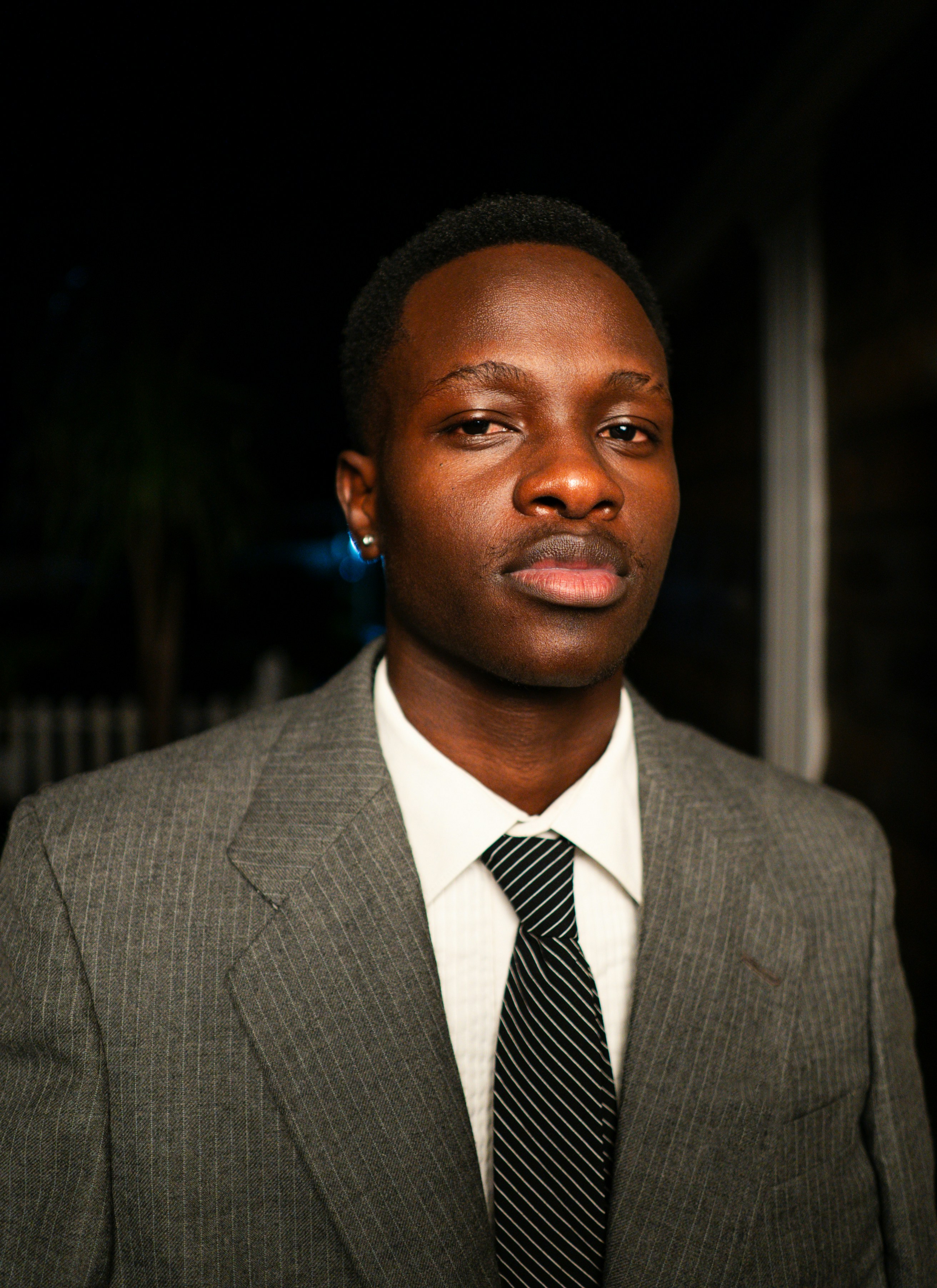 A young black man in a suit and tie.