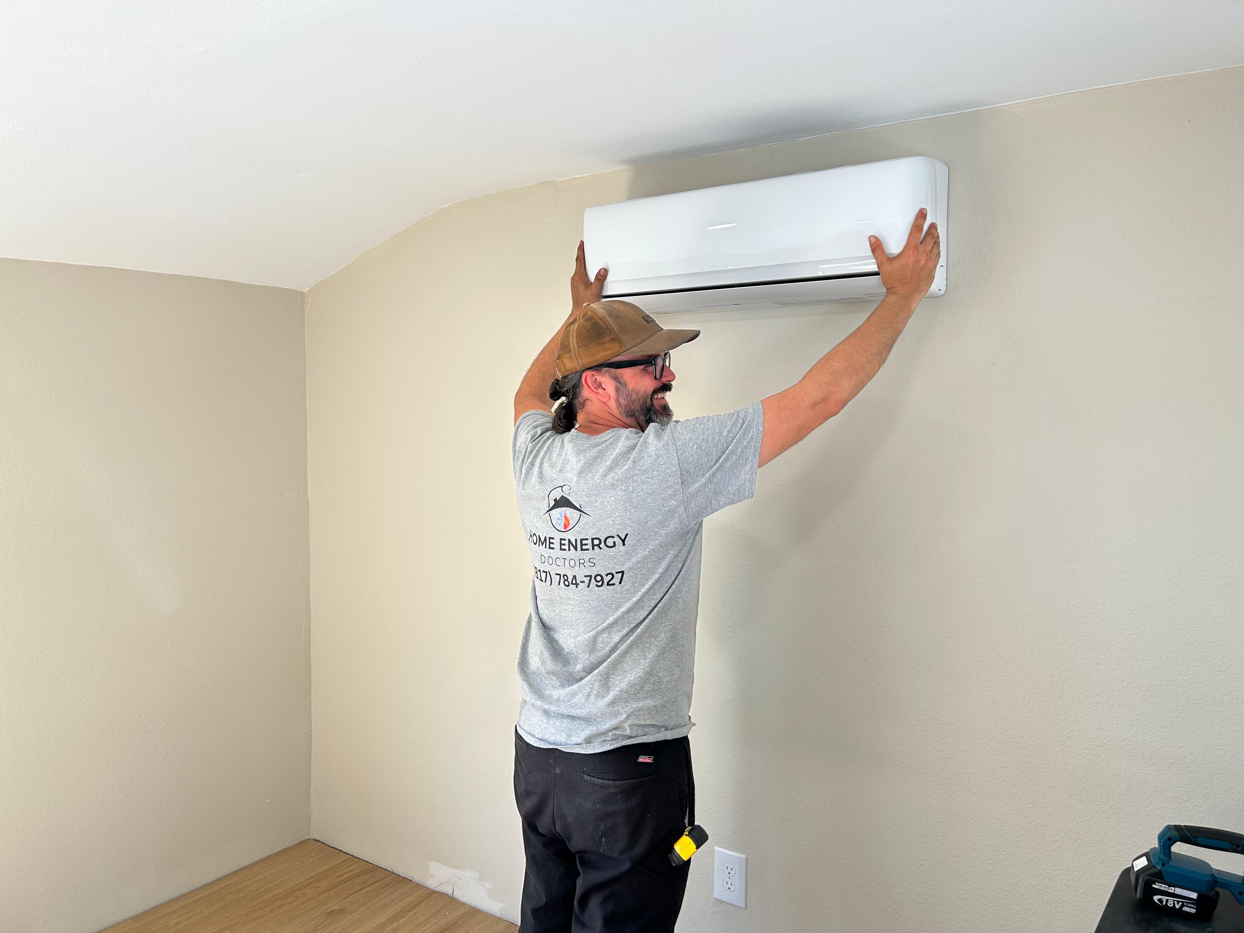 Technician installing indoor HVAC unit during service visit in Fort Worth home