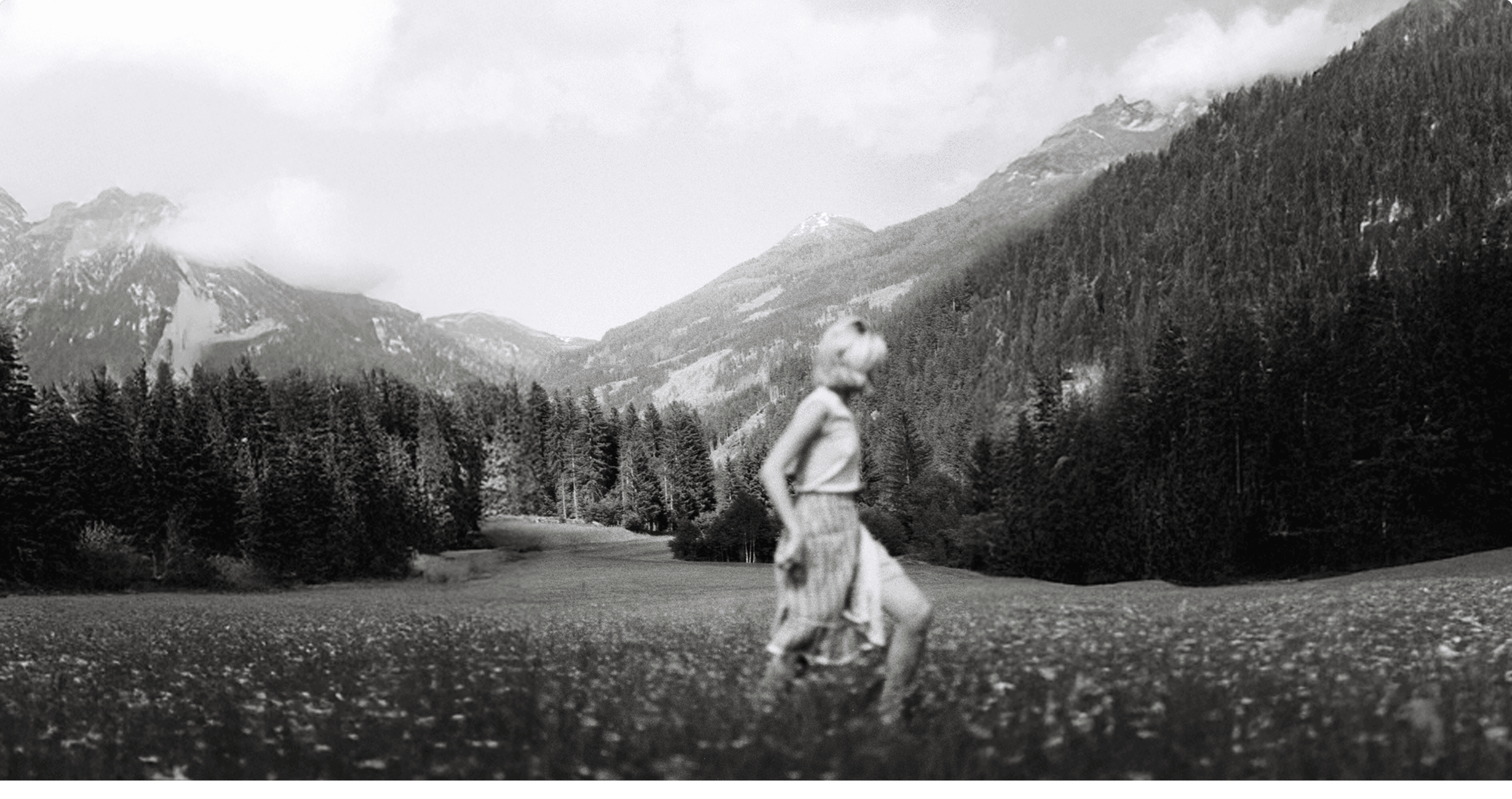 A black and white photo of a hand squeezing a handful of soap bubbles.