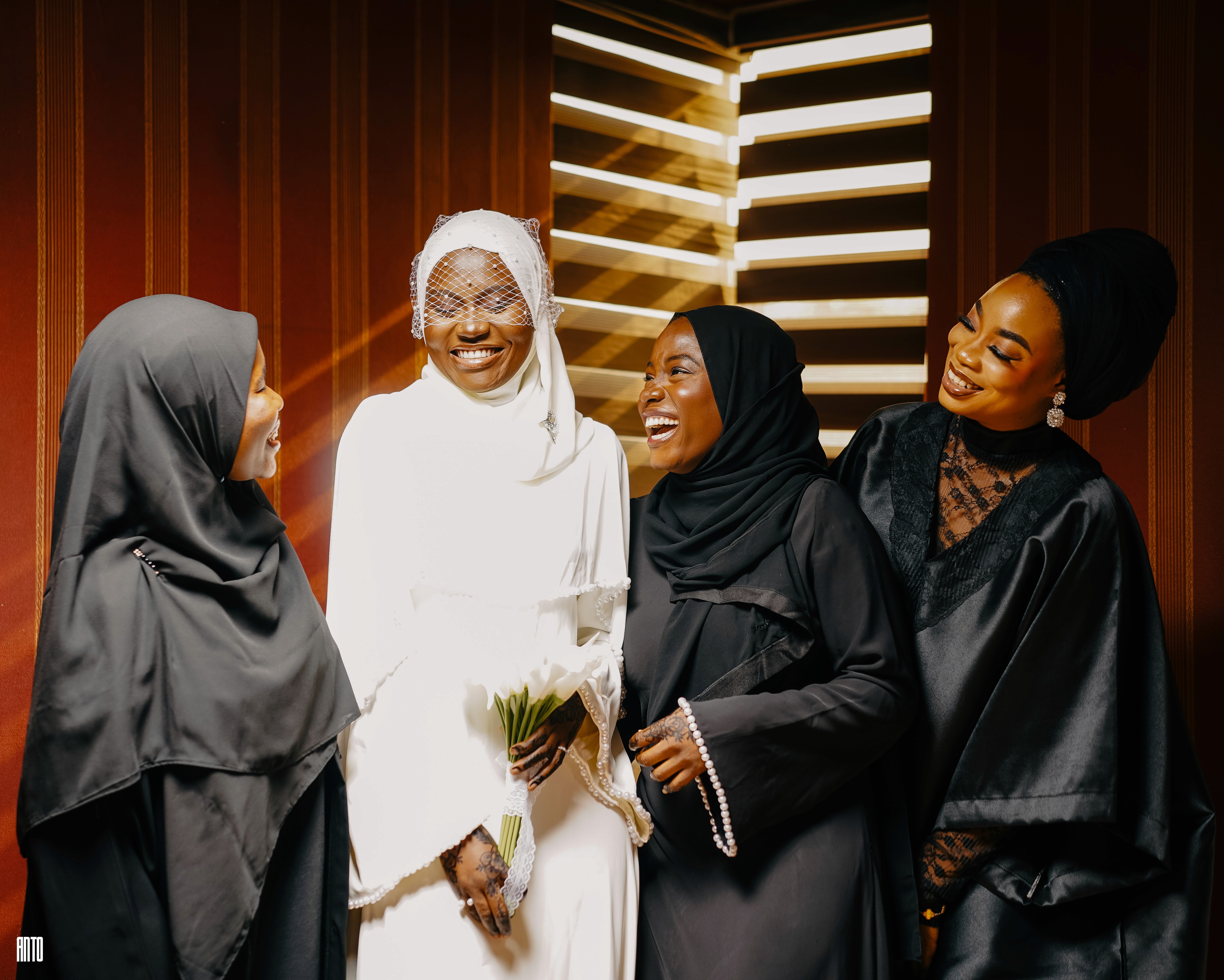 A man poses in a blue, monochromatic setting.
