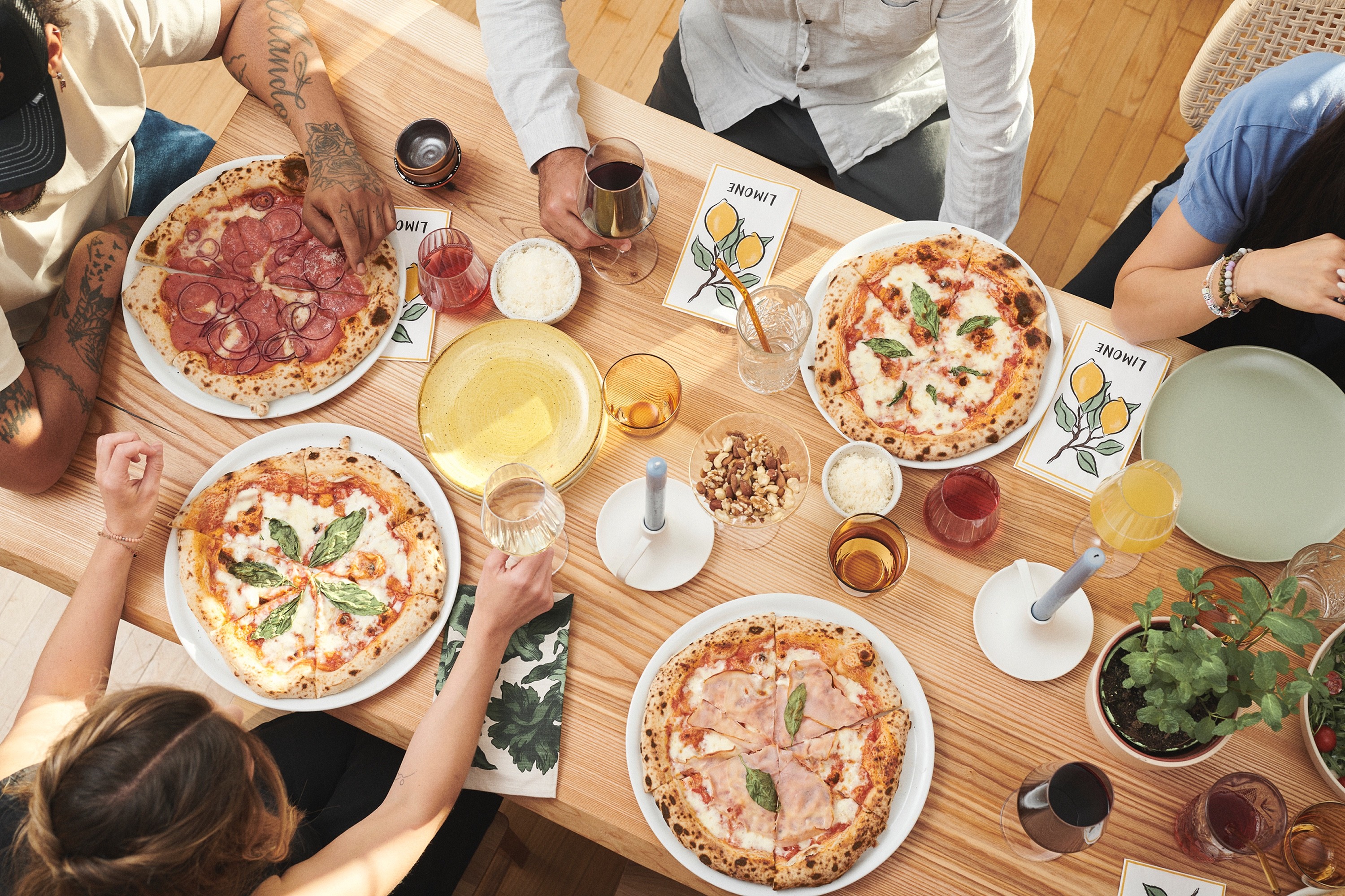 Dynamic close-up of a runner’s foot mid-stride on a muddy forest trail, wearing black socks and red trail shoes with visible sole pattern.