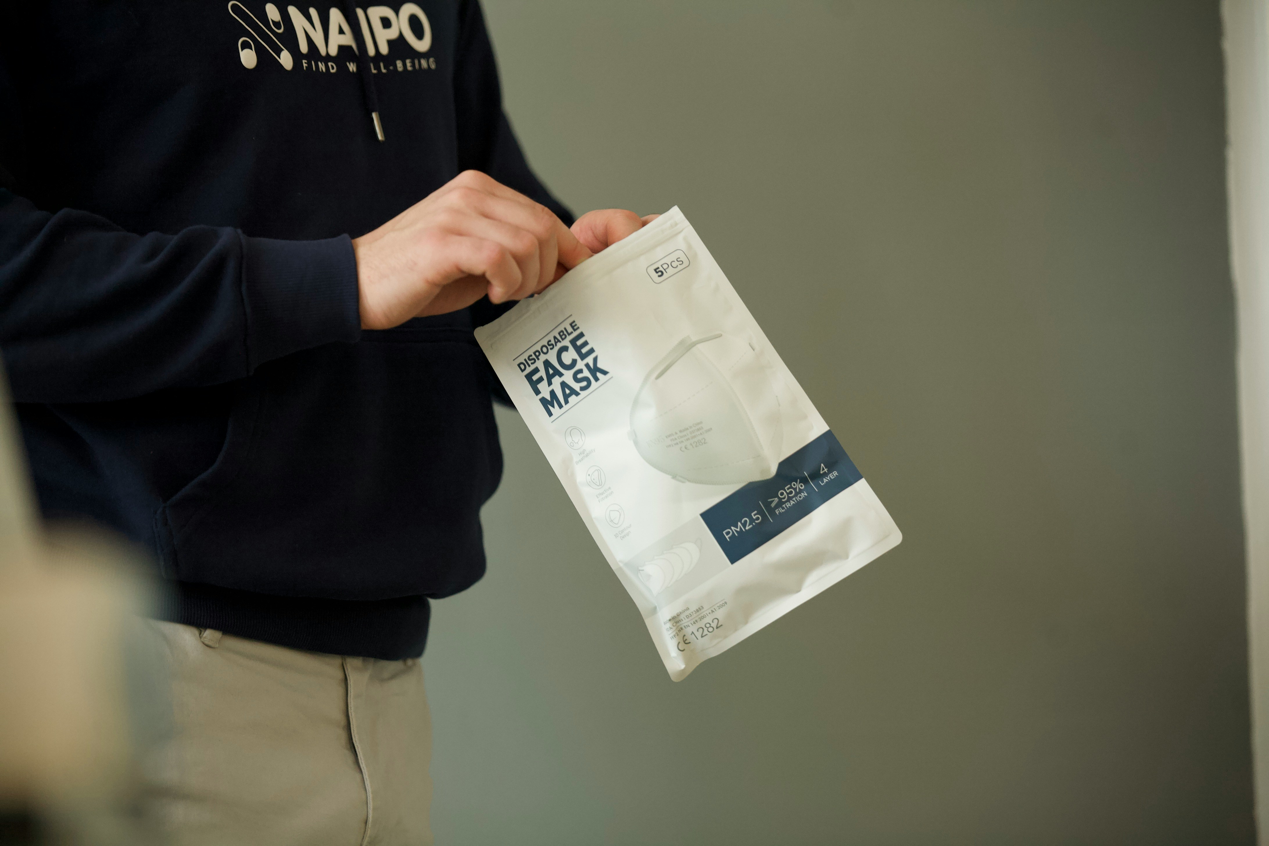 A Picture showing a Human holding a bag of paper, that is symbolising prioritisation