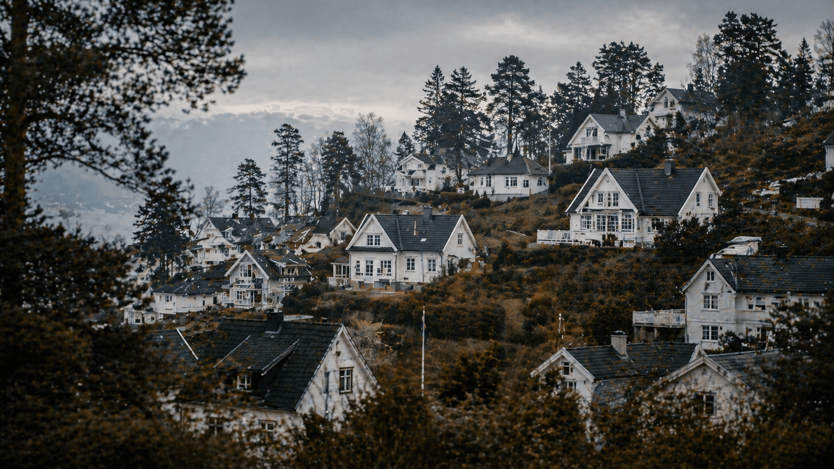 A silhouette of a person standing amidst vibrant swirling colors of teal and orange.