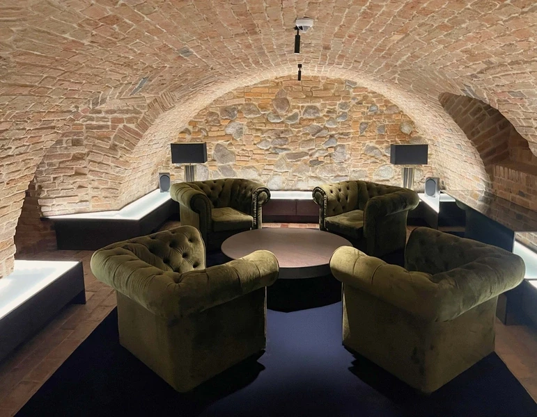  a room with green armchairs and a coffee table