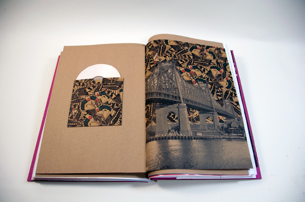an opened book with an illustration of a bridge