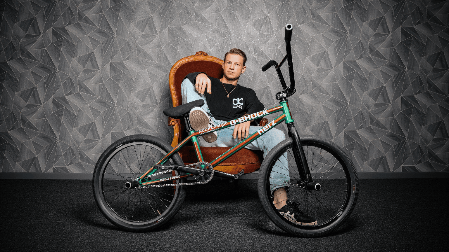 Black and white portrait of a smiling person with curly hair