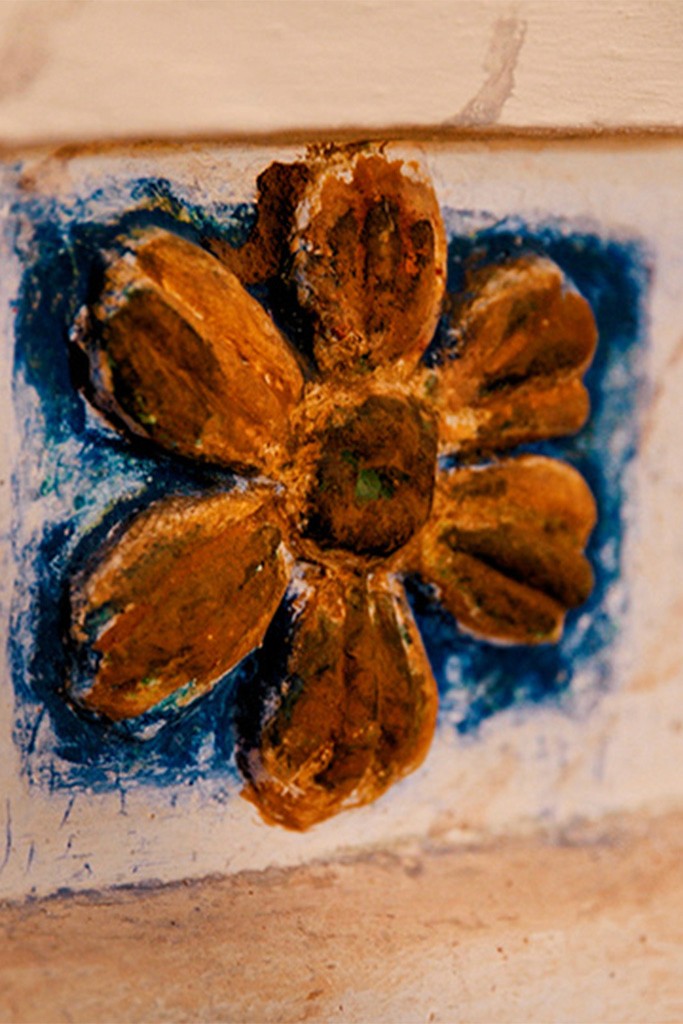 A vibrant bridal bouquet featuring a mix of red, pink, and purple flowers.