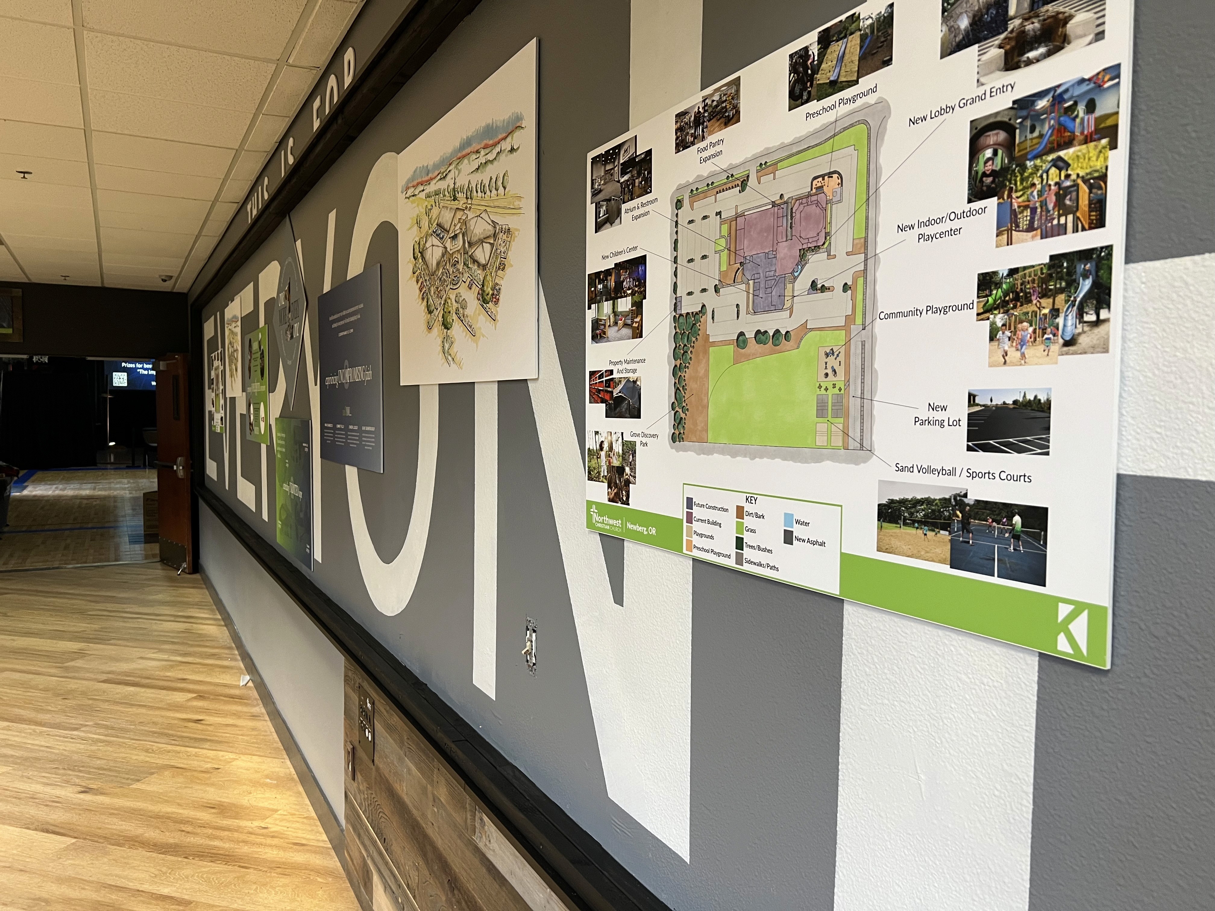 Modern home office setup with a monitor, ergonomic chair, keyboard, and indoor plants near a window with blinds.