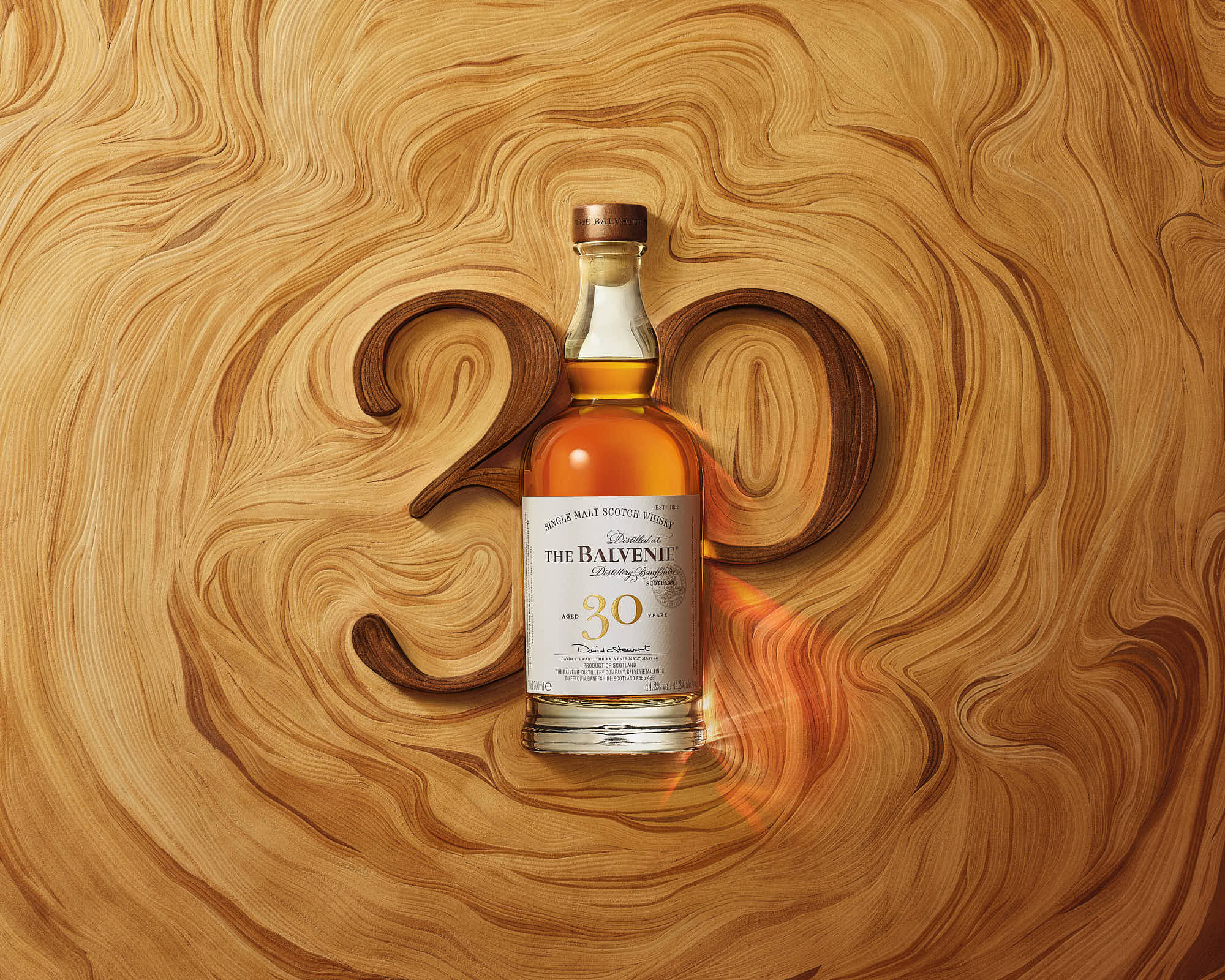 A wooden surface features the number 30 with an orange key tag and a small white card hanging from it.