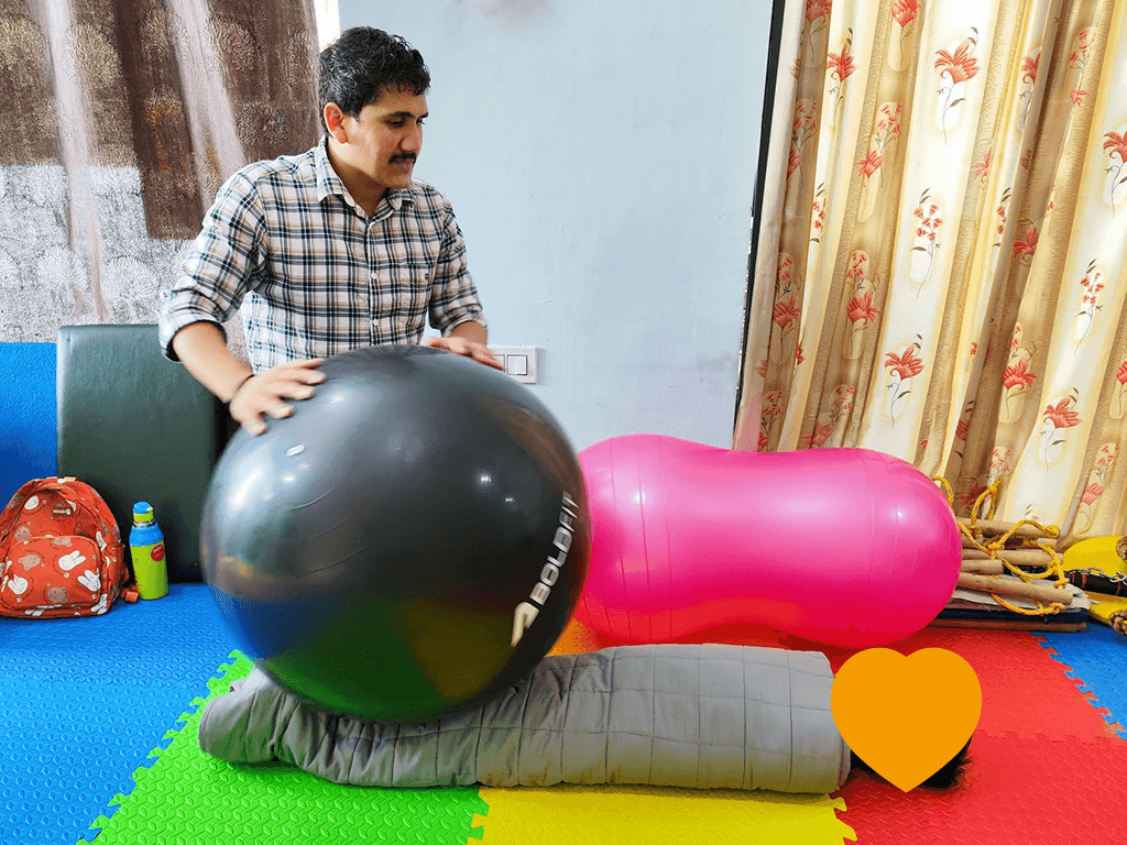 Blissful Care Center multidisciplinary pediatric therapy team in clinic — occupational therapist, speech therapist and child during session