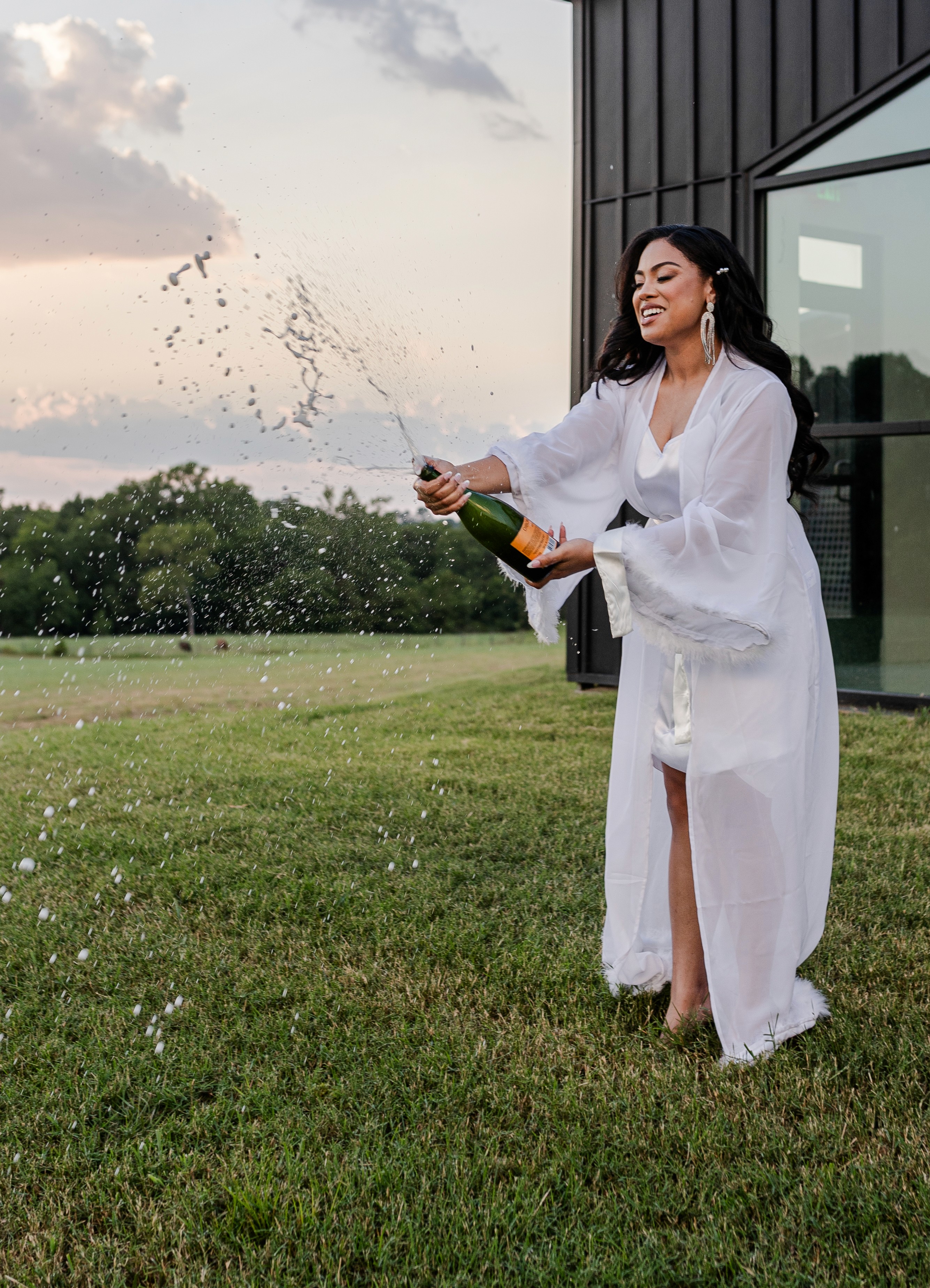 Bride popping champagne at the homestead in Willis, Texas WEdding photographer