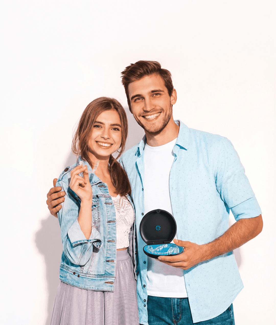 Invisalign in Dubai with a woman smiling confidently, holding her clear aligners, highlighting discreet and effective treatment.