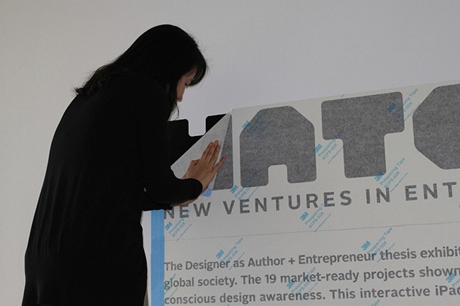A photo of a person imprinting on a wall the text Hatched along with other useful information.