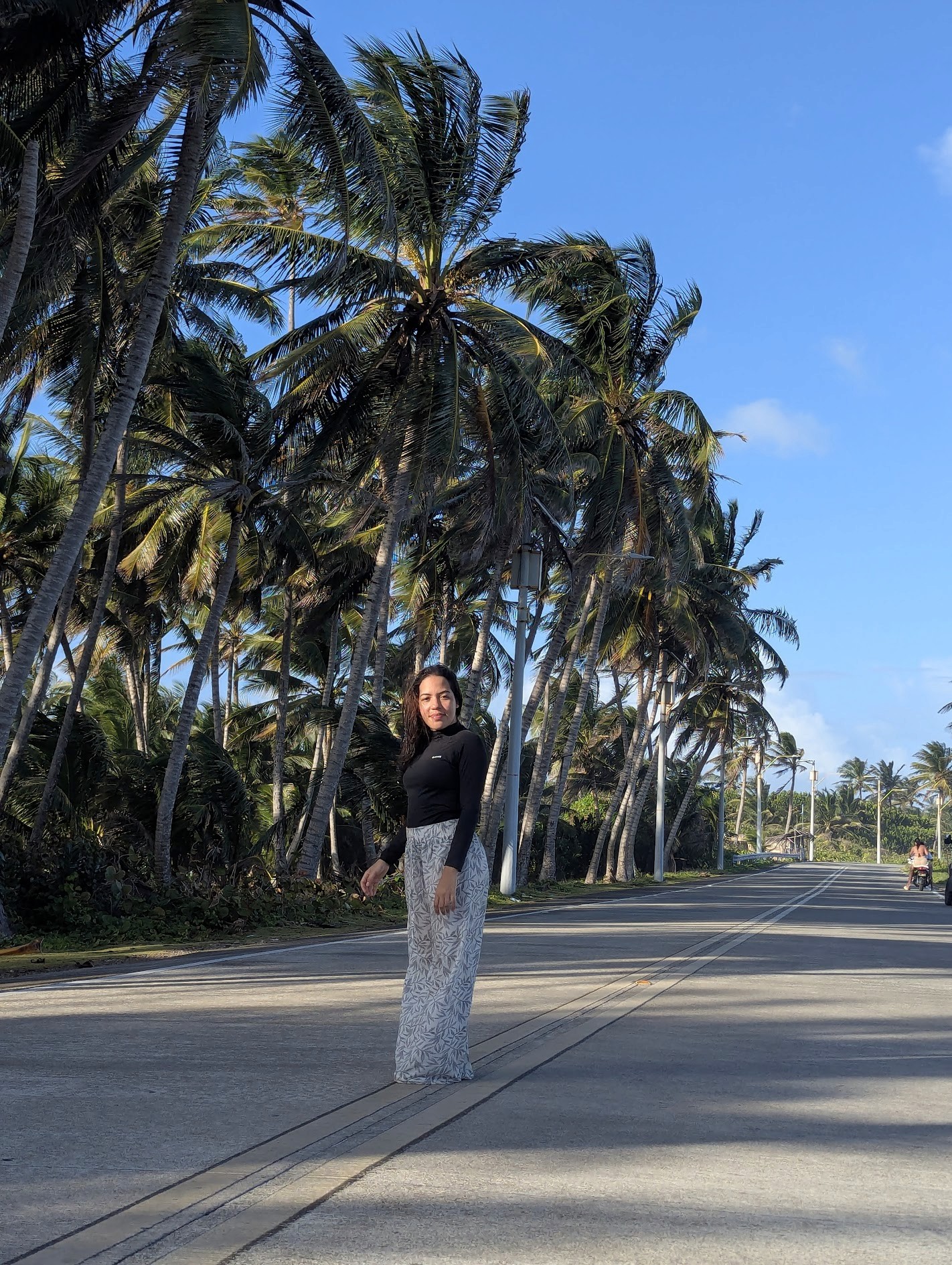 person with palms in the background