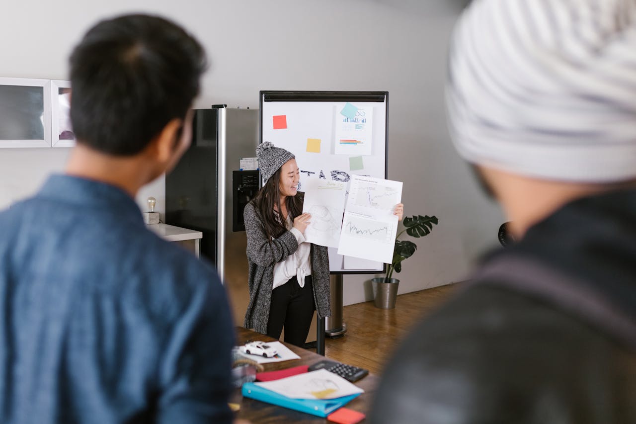 a women showing project papers in a meeting