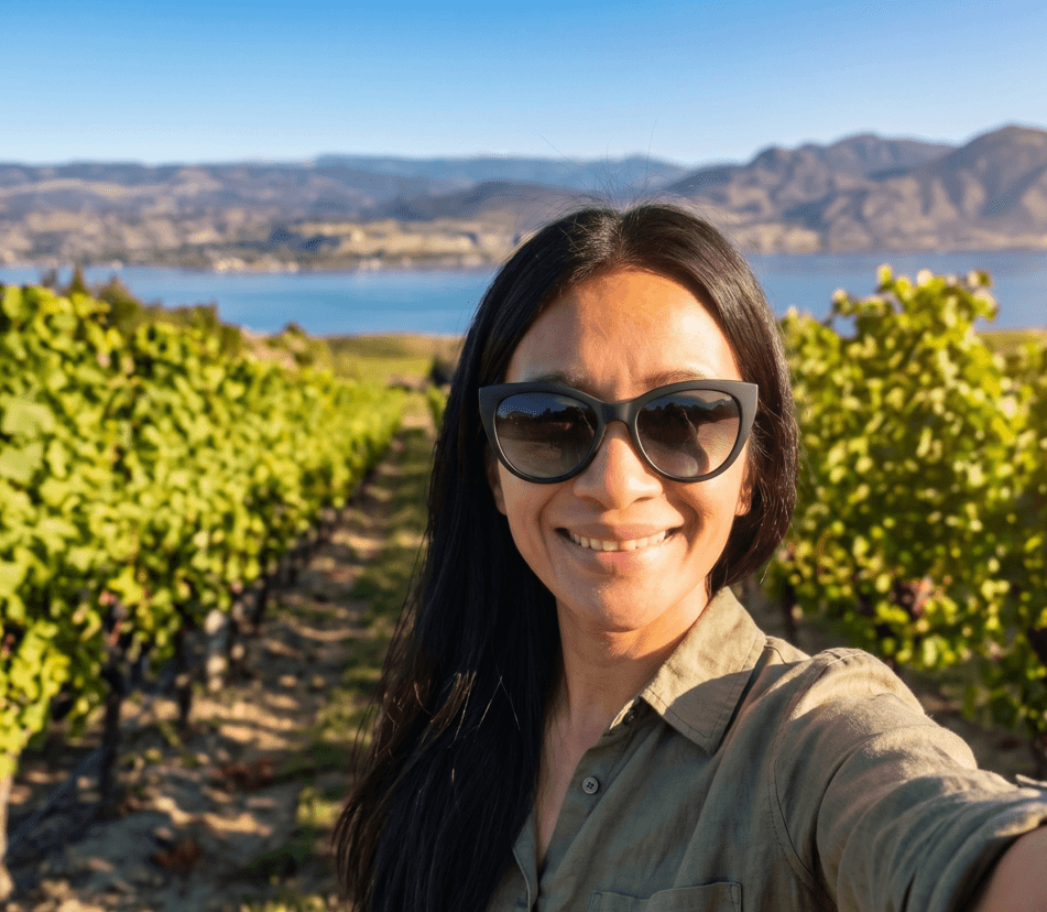 A Young woman in grey blueish background smiling