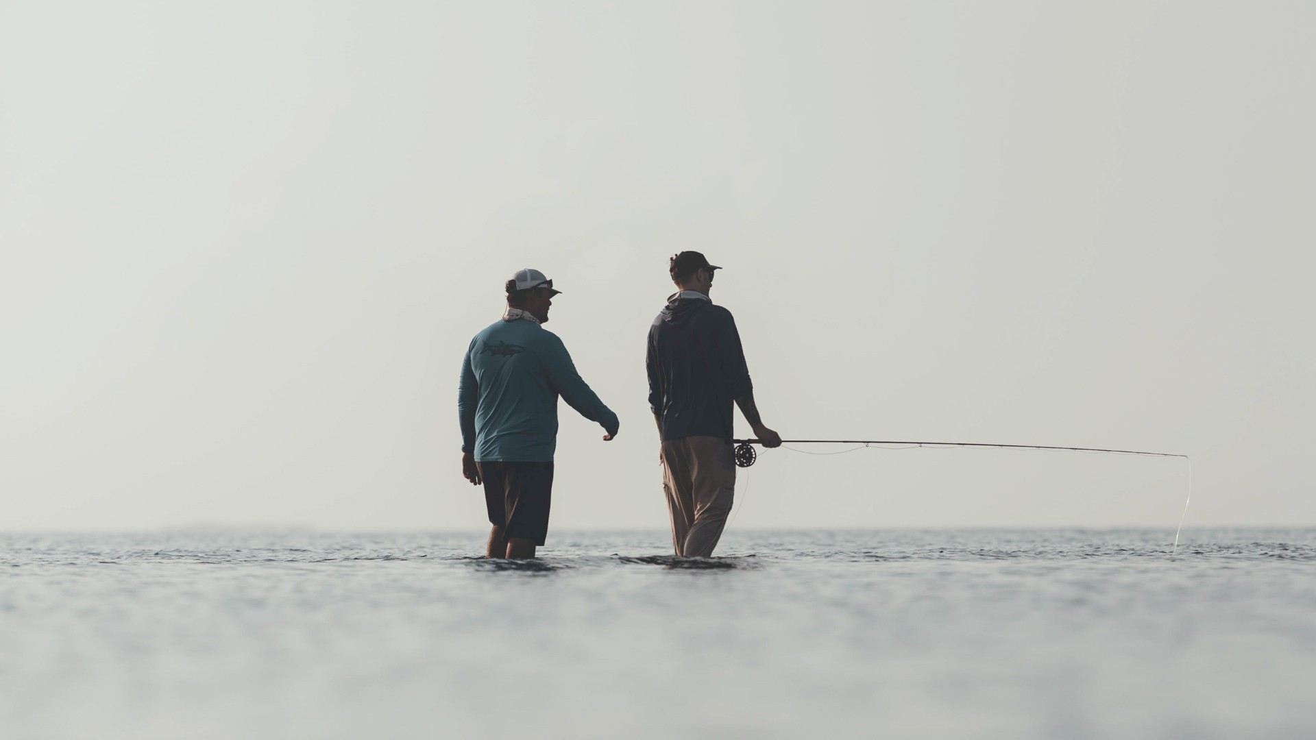 Marlon Leslie vading in skinny water with angler