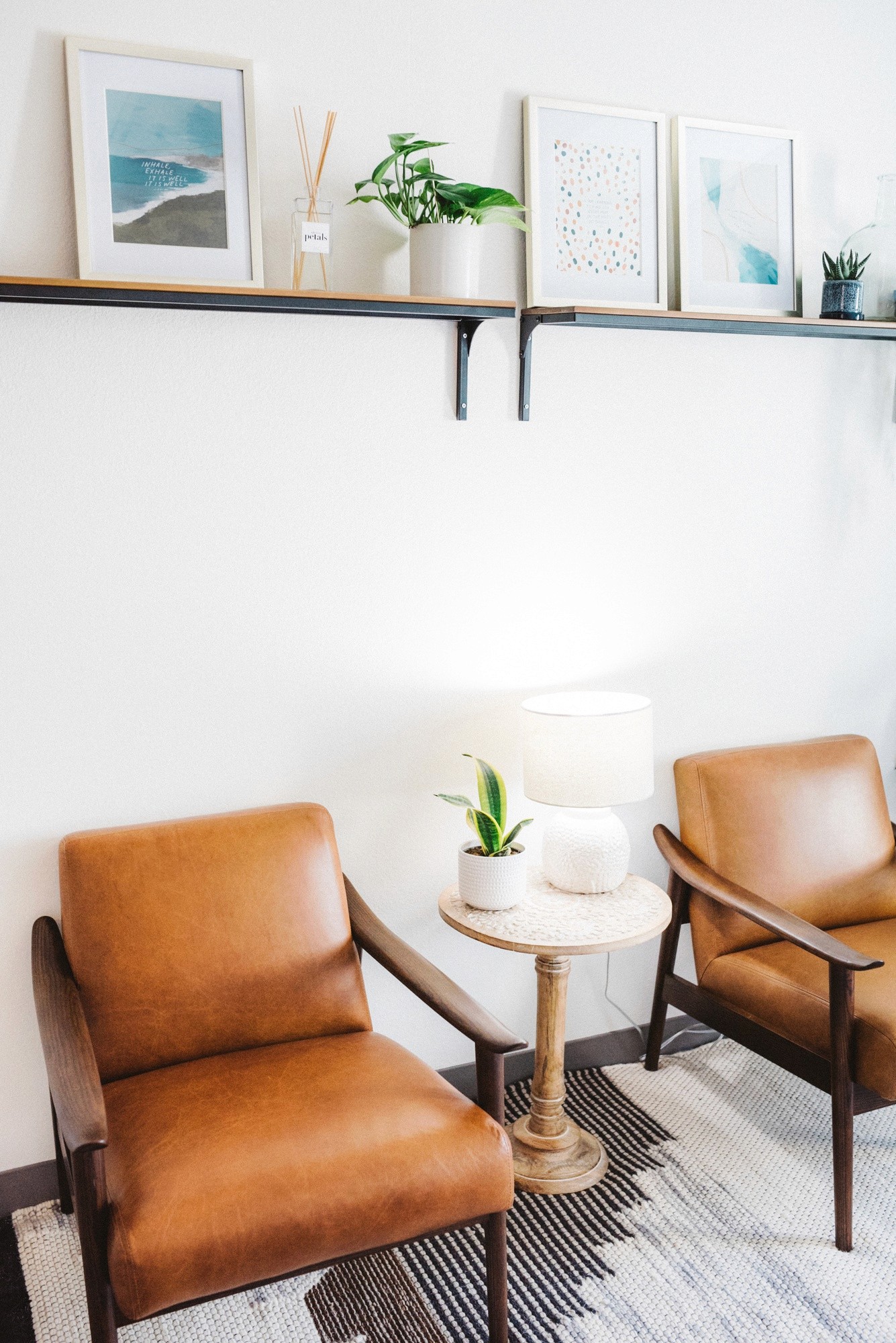 A calm and welcoming counselling room with two leather armchairs at an NI Counselling practice