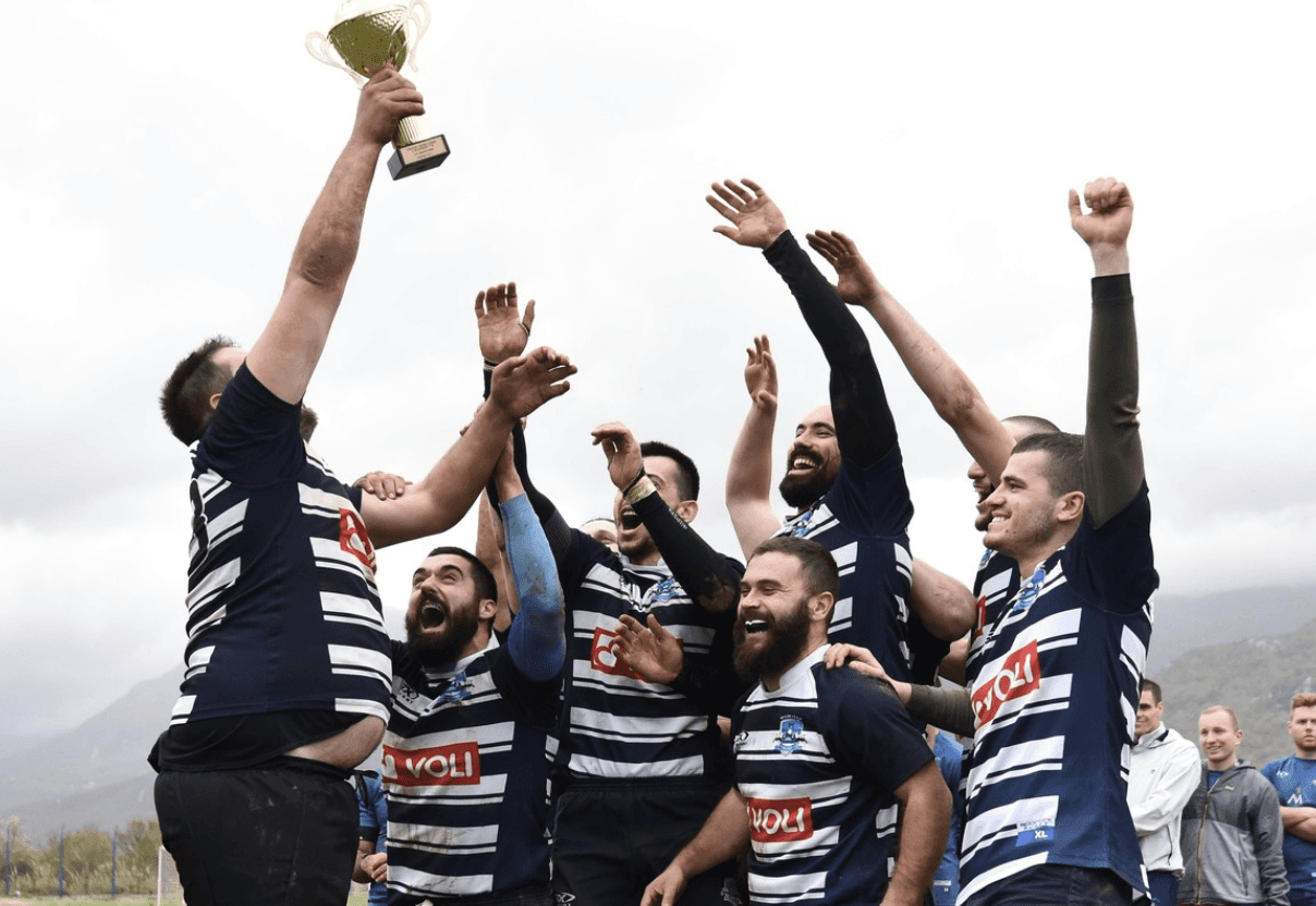 team celebrating with trophy