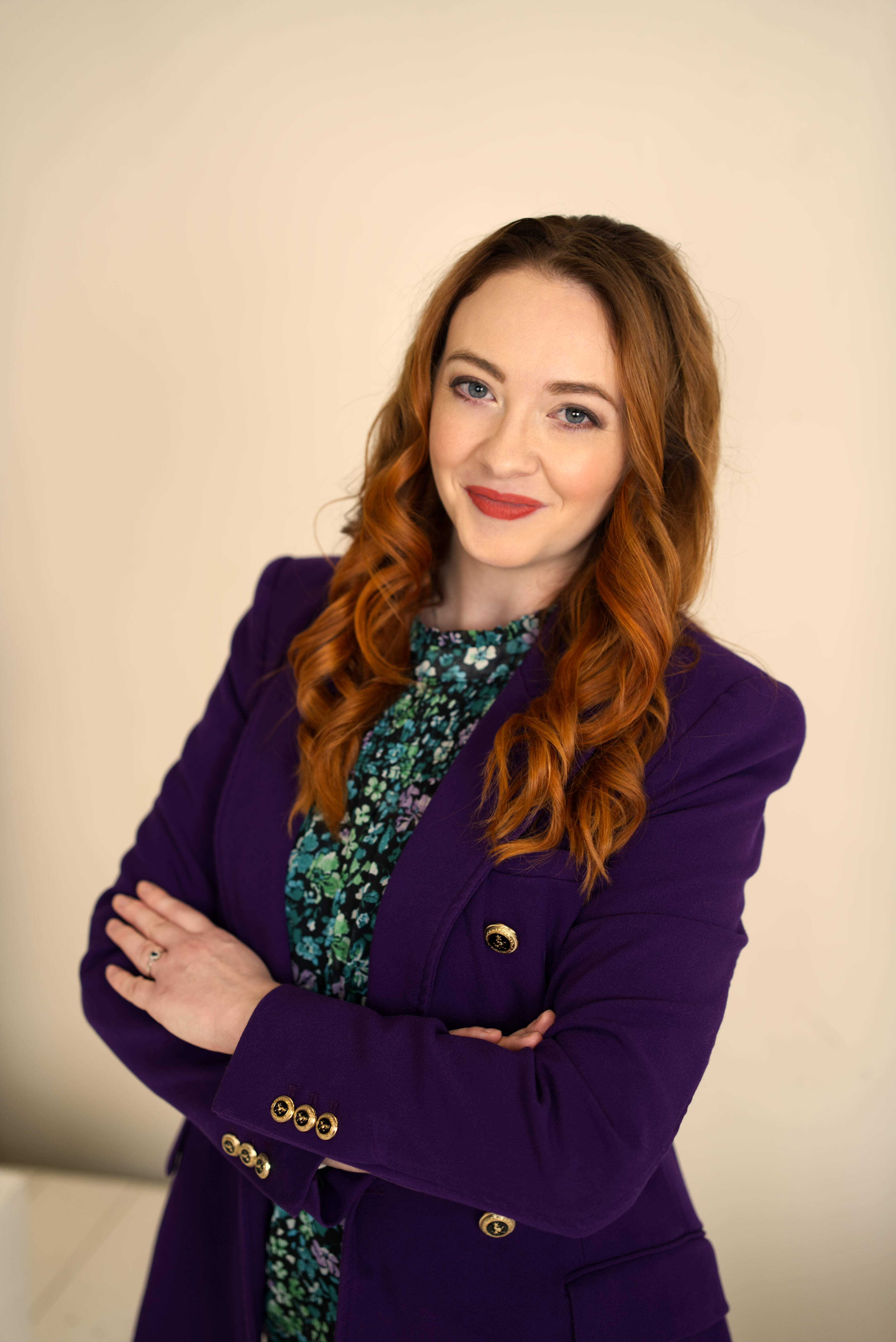 A woman in a straw hat stands in the grass