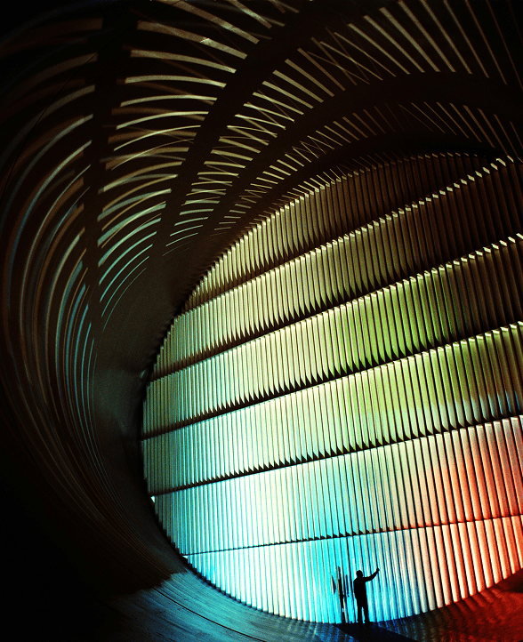 Modern glass building reflected in angled grid lines