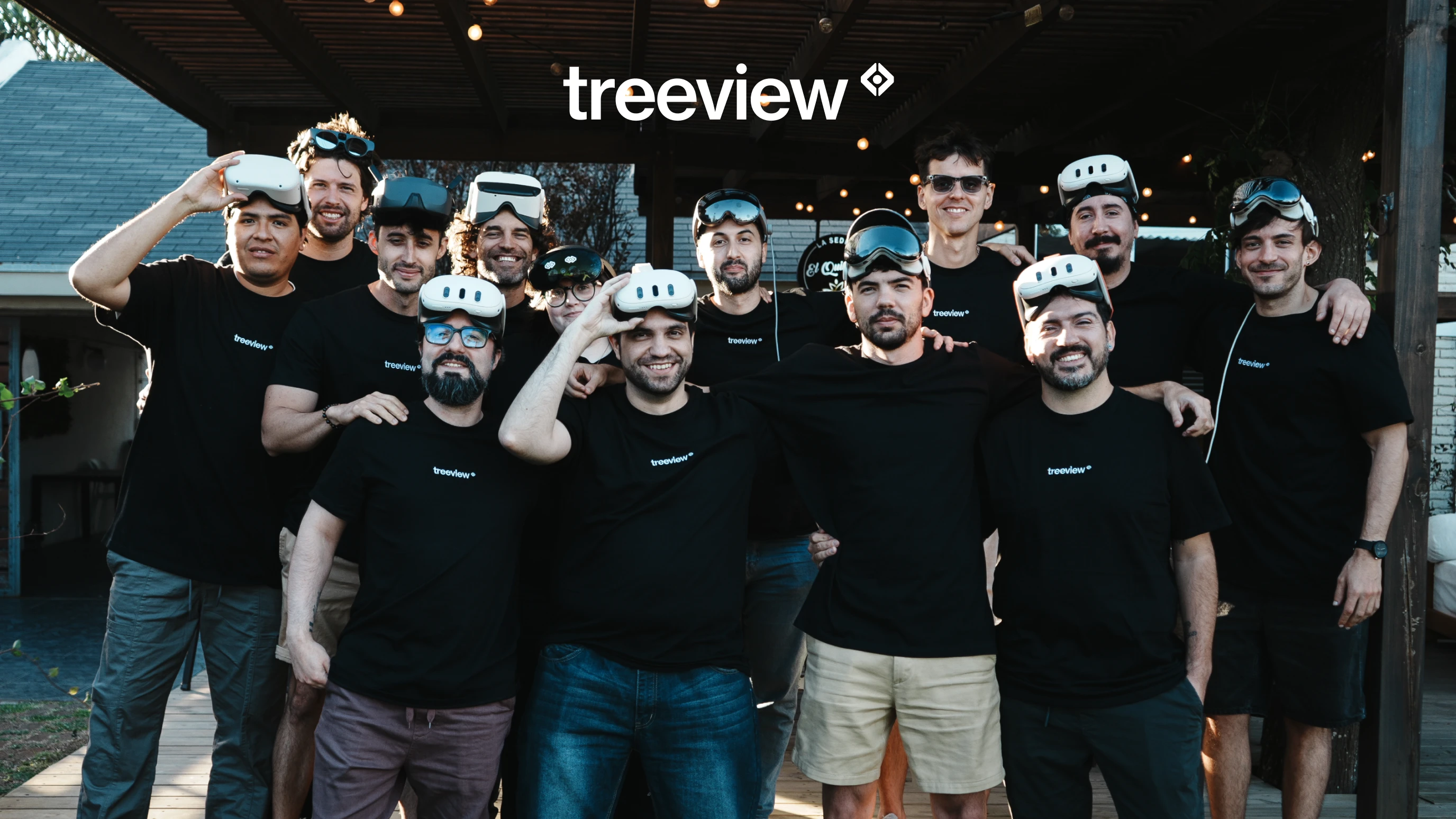 Treeview team members in black branded shirts pose together with VR headsets and smart glasses outdoors.