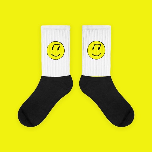 photo of graphic design work with smiley faces and yellow background 