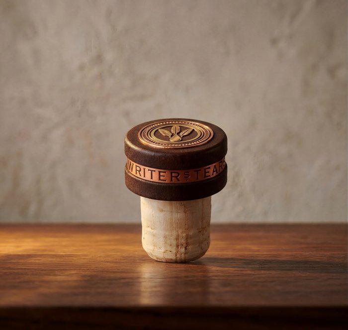 Wooden and copper writing instrument component instance.