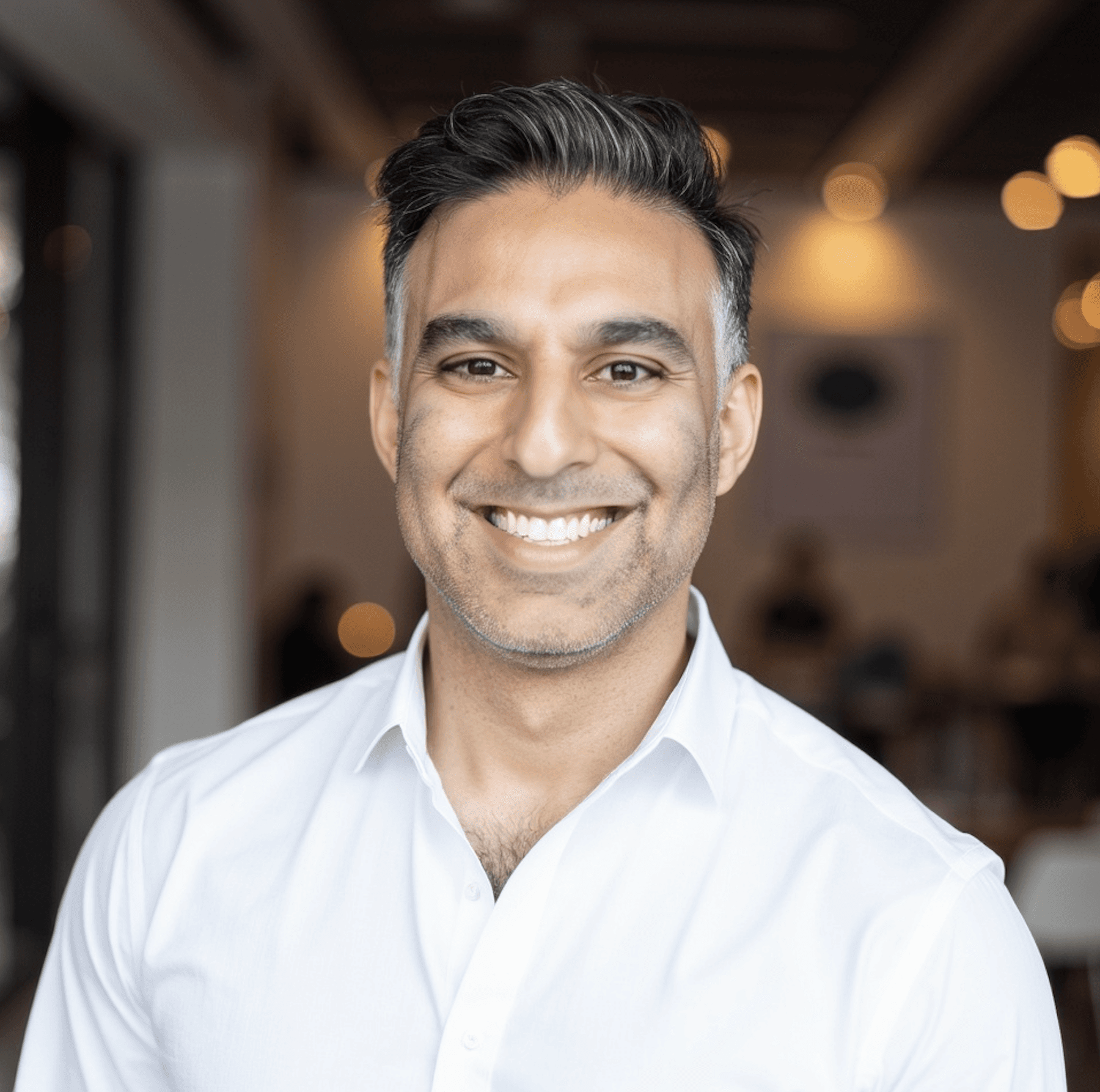 Traveler walking across golden sand dunes in AlUla under morning light.