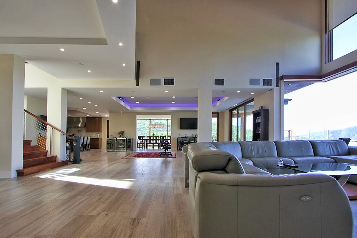 Interior living room with high ceilings and expansive windows.